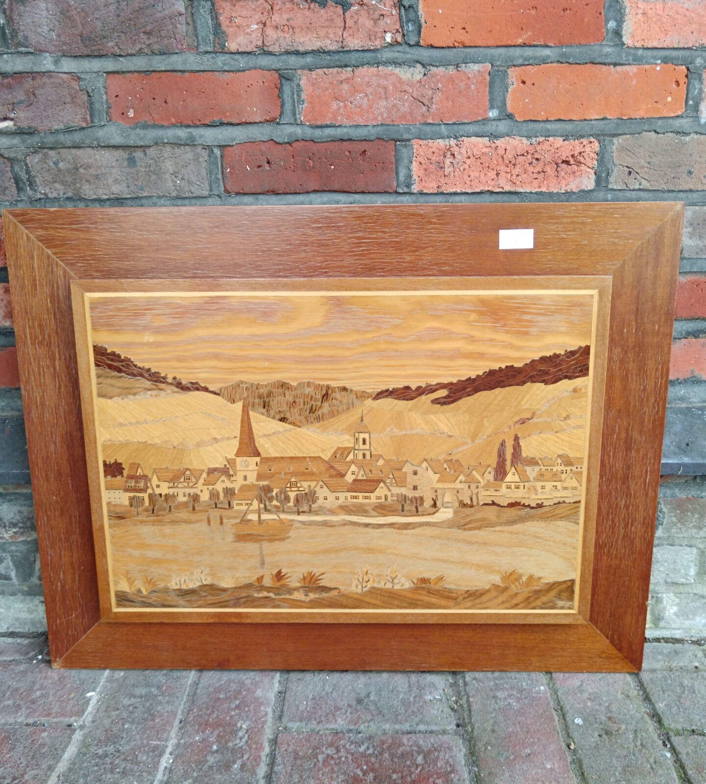 Large marquetry panel signed f f of a lake side village with churches