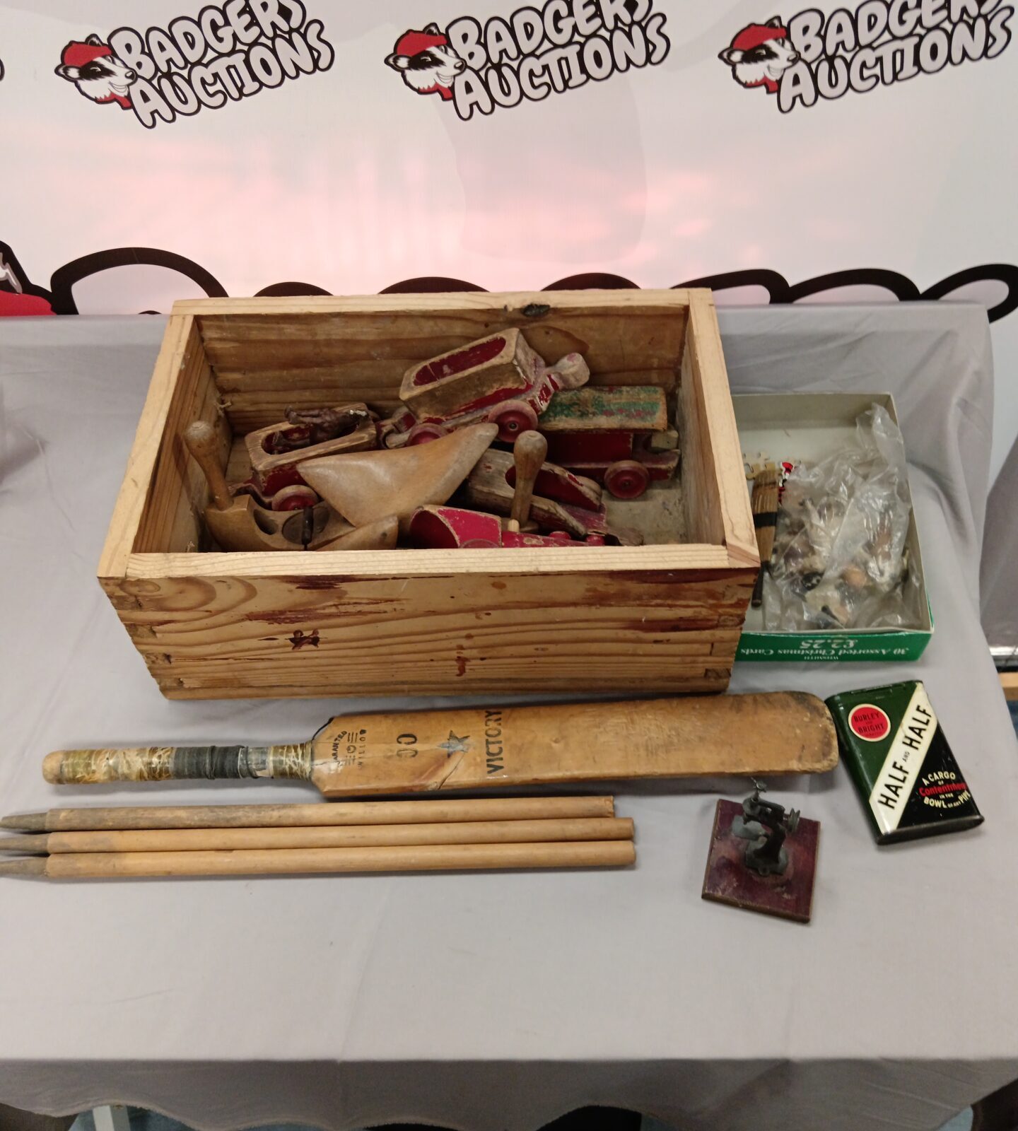 Wooden box of vintage wooden toys including cricket bat