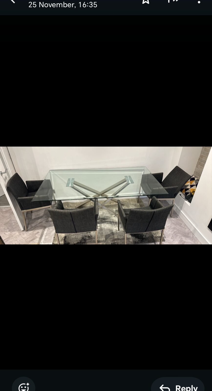 Modern glass topped dining table with four chairs