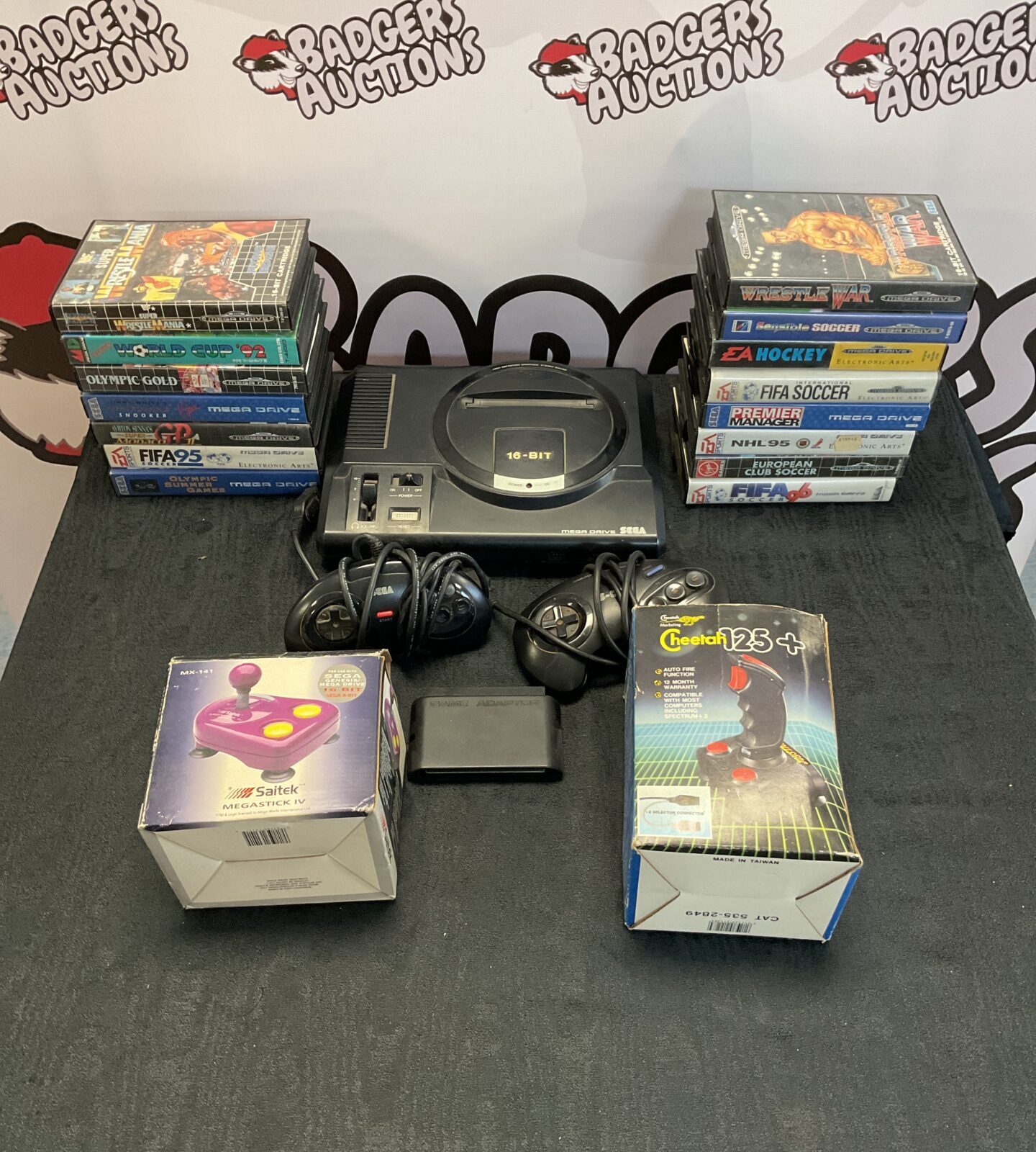 Sega megadrive with cables, two controllers, two joysticks and collection of 15 boxed games including super wrestle mania and Ayrton Senna’s super Monaco GP2