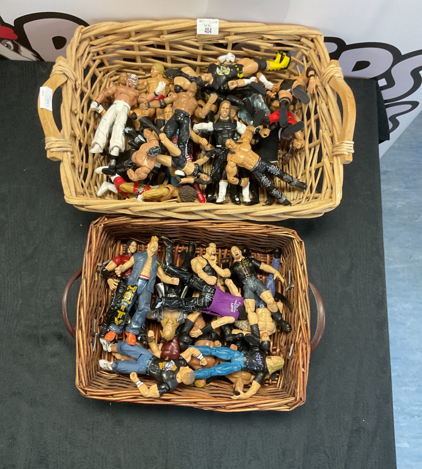 Two wicker baskets containing a selection of WWE figurines