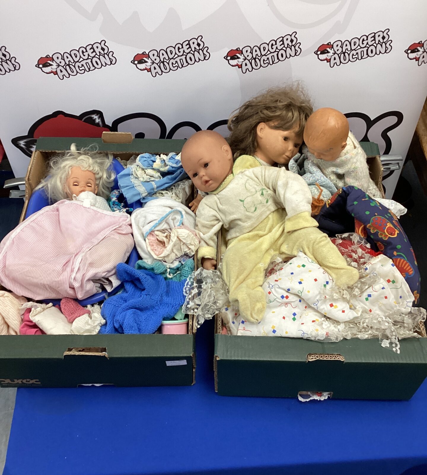 Two trays of assorted dolls & clothing