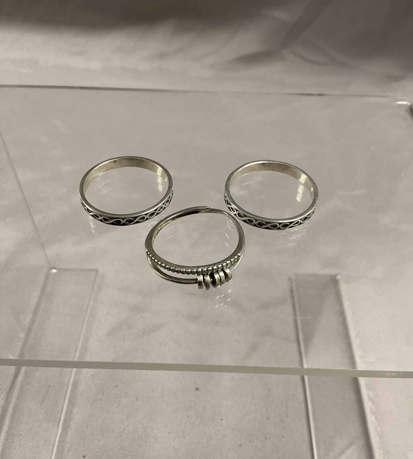 Three 925 Silver rings sizes U W