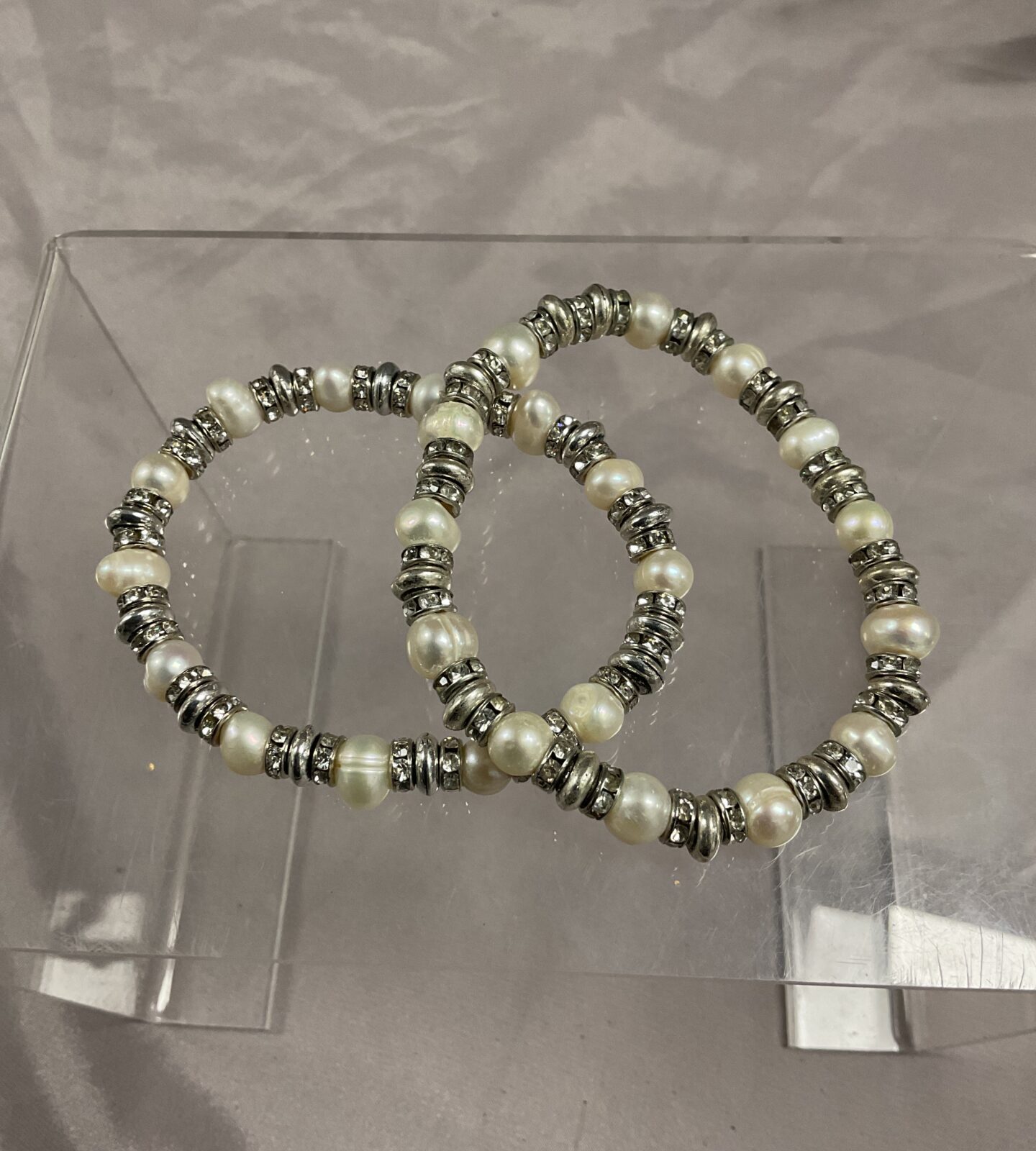 two pearl and silver metal bracelets