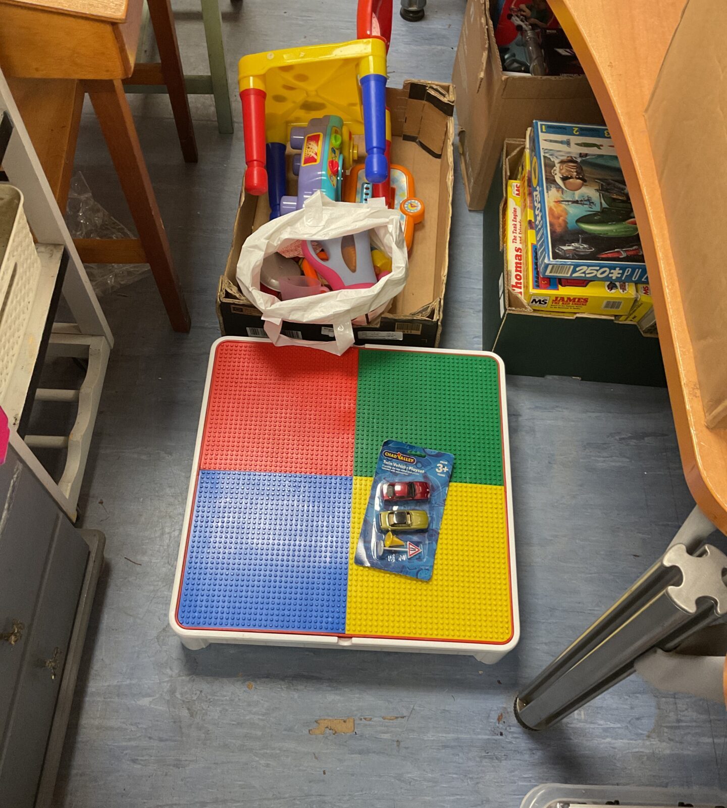 Mixed items inc lego childrens table, bag of kitchen toys and unopened pack of chad valley twin vehicle playset