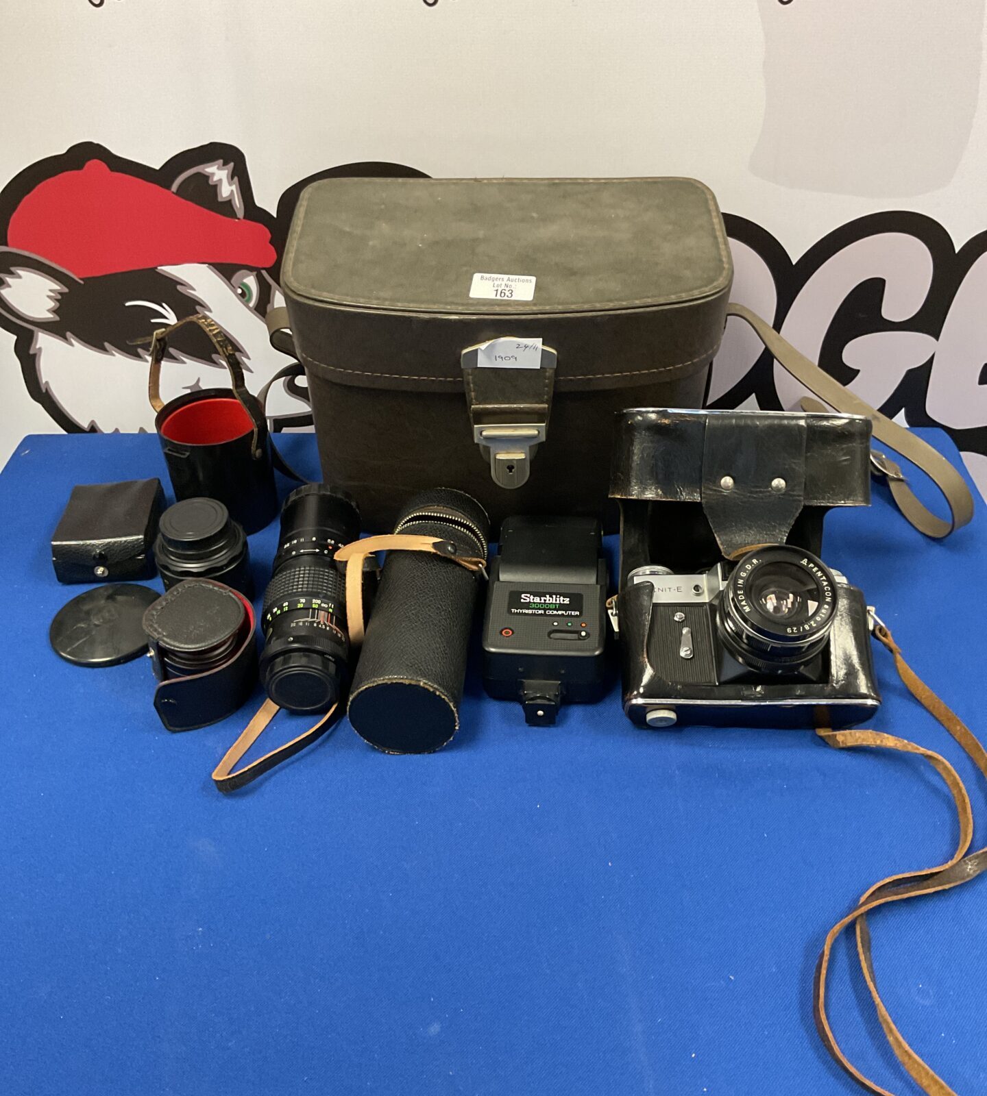 Zenit-e camera with various accessories including lenses and flash