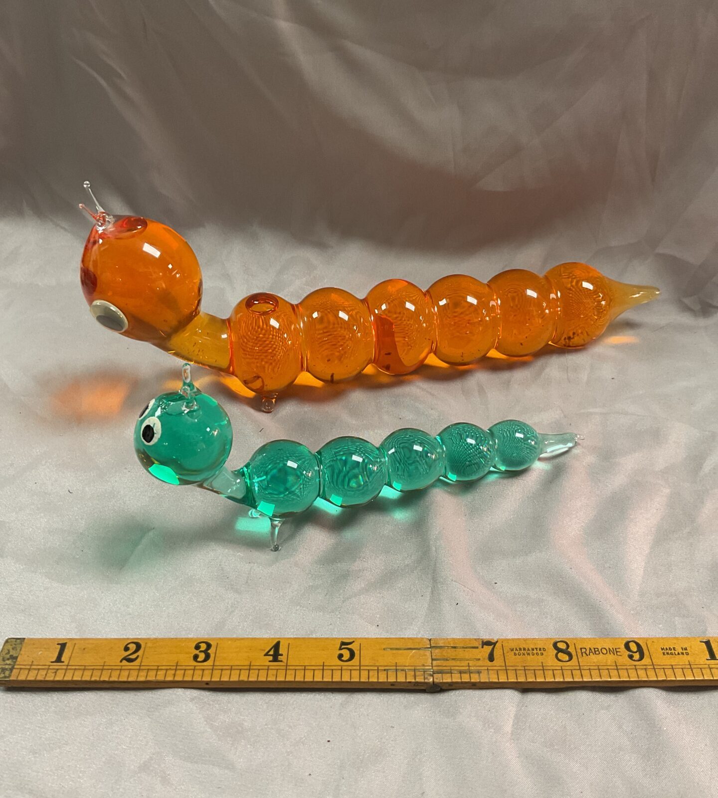 Two liquid filled glass caterpillars