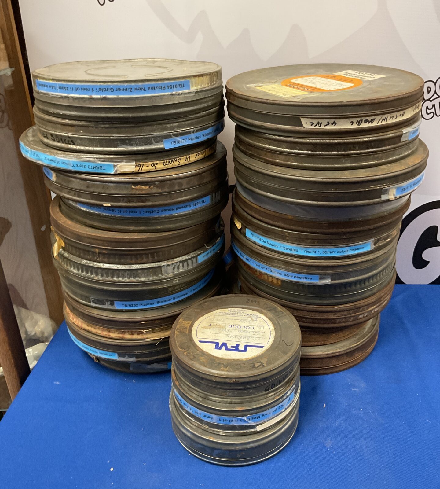 Job lot of 35mm film reel adverts in cans including Maxwell house coffee and Du Maria cigarettes