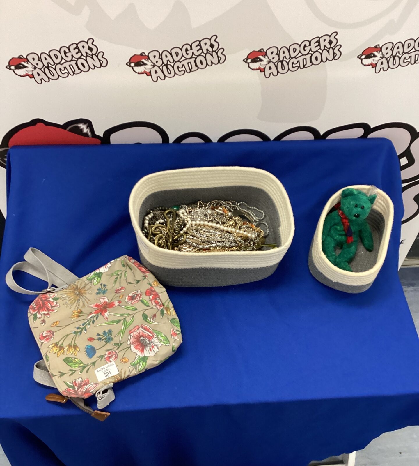 Box of costume jewellery with teddy bear and wash bag