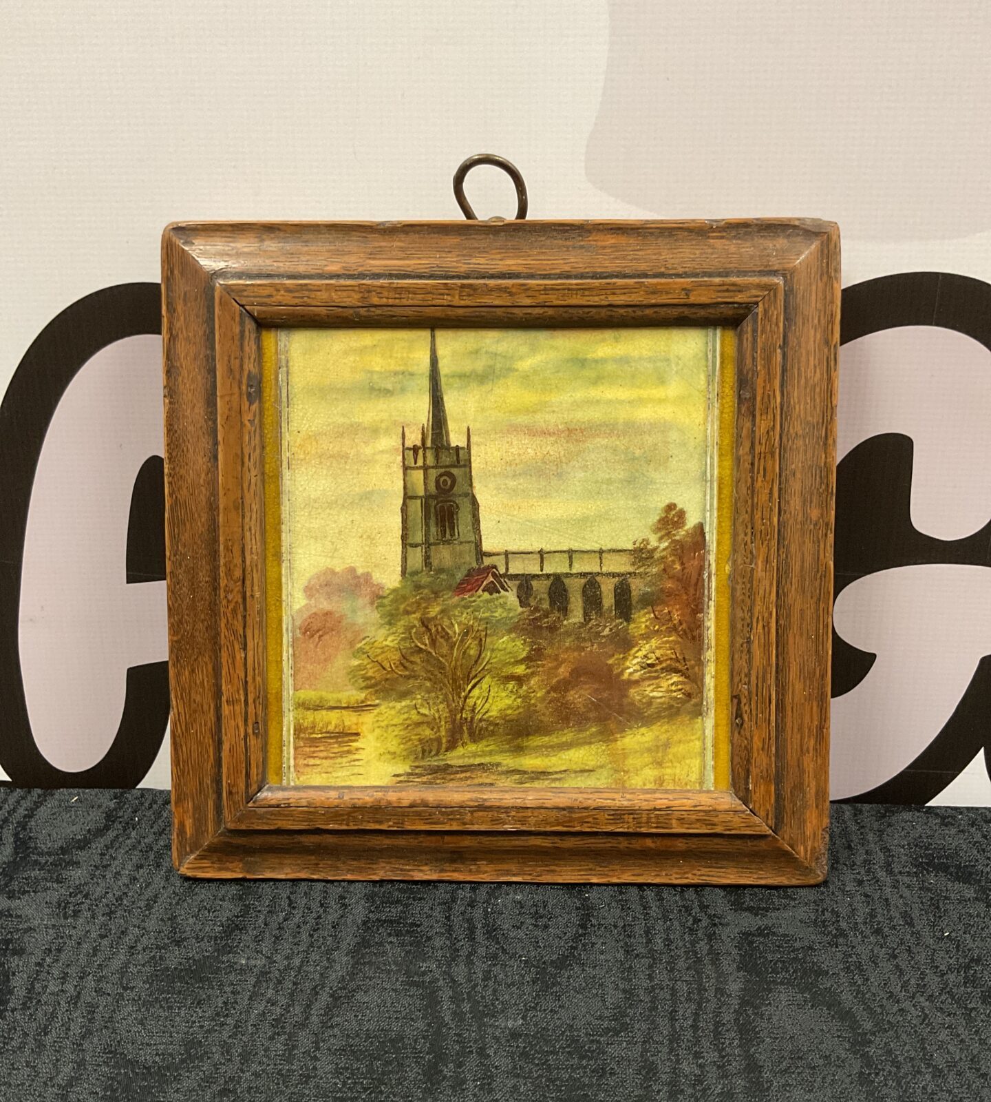 framed victorian painted ceramic tile of a church by stream