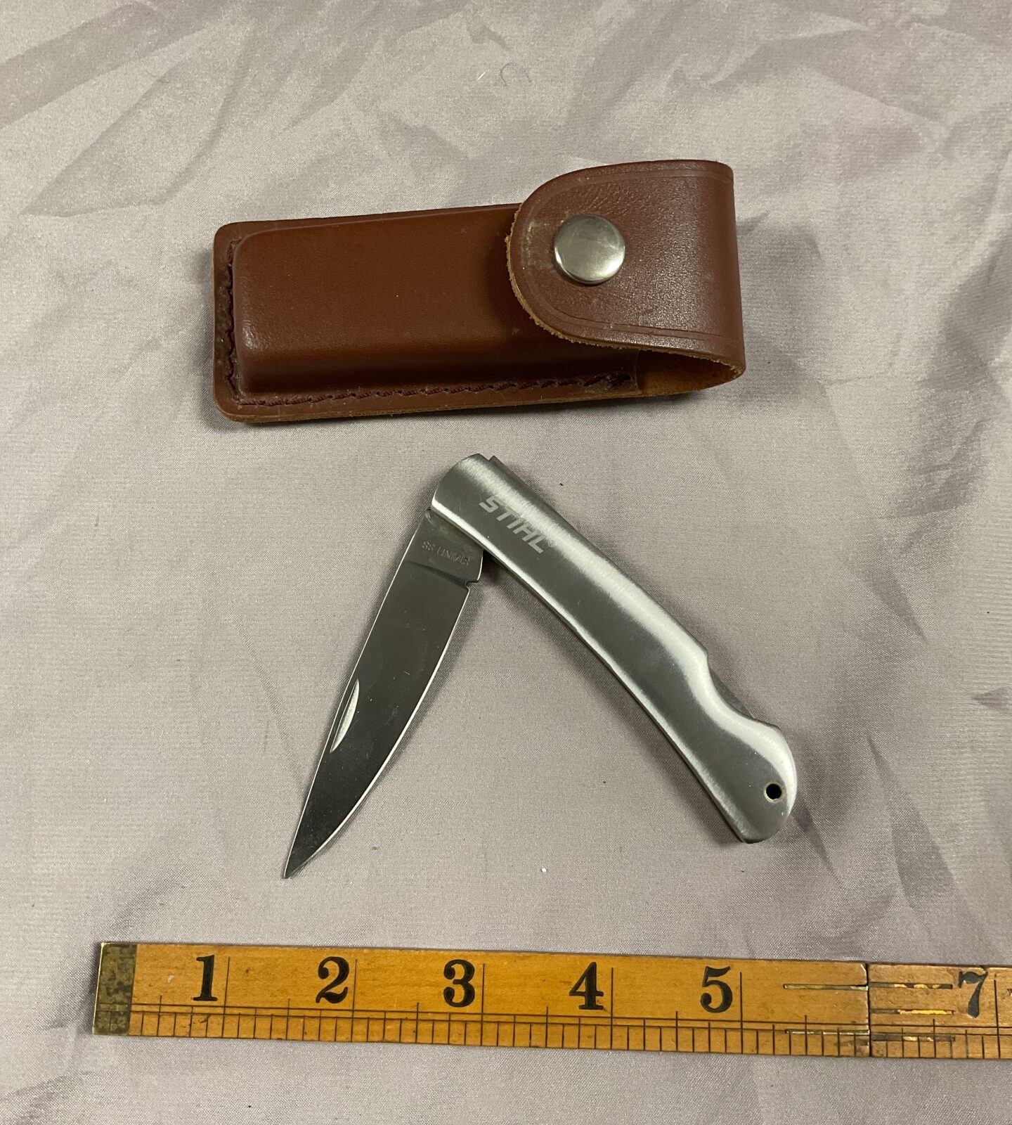 Stihl stainless steel pocket knife with leather pouch