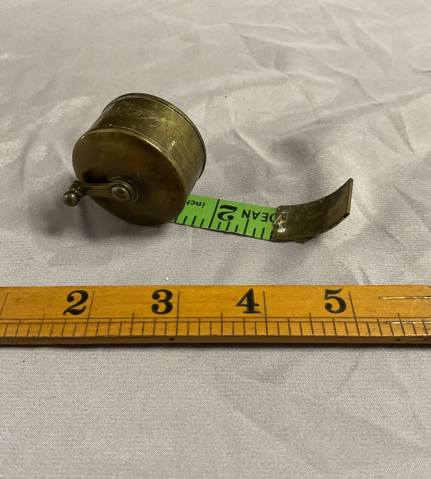 Vintage brass reel tape measure