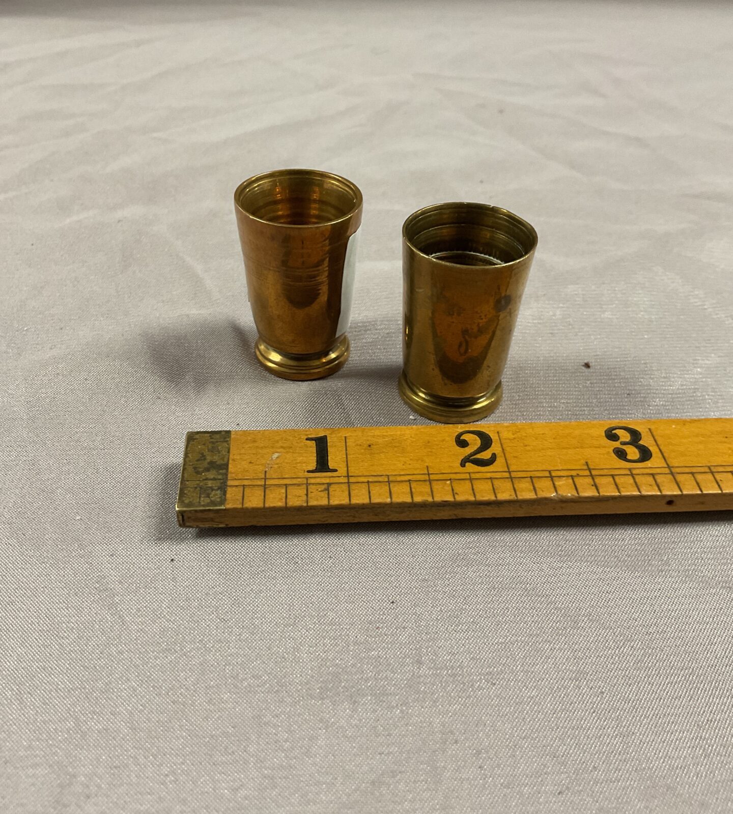 Two small brass shot cups