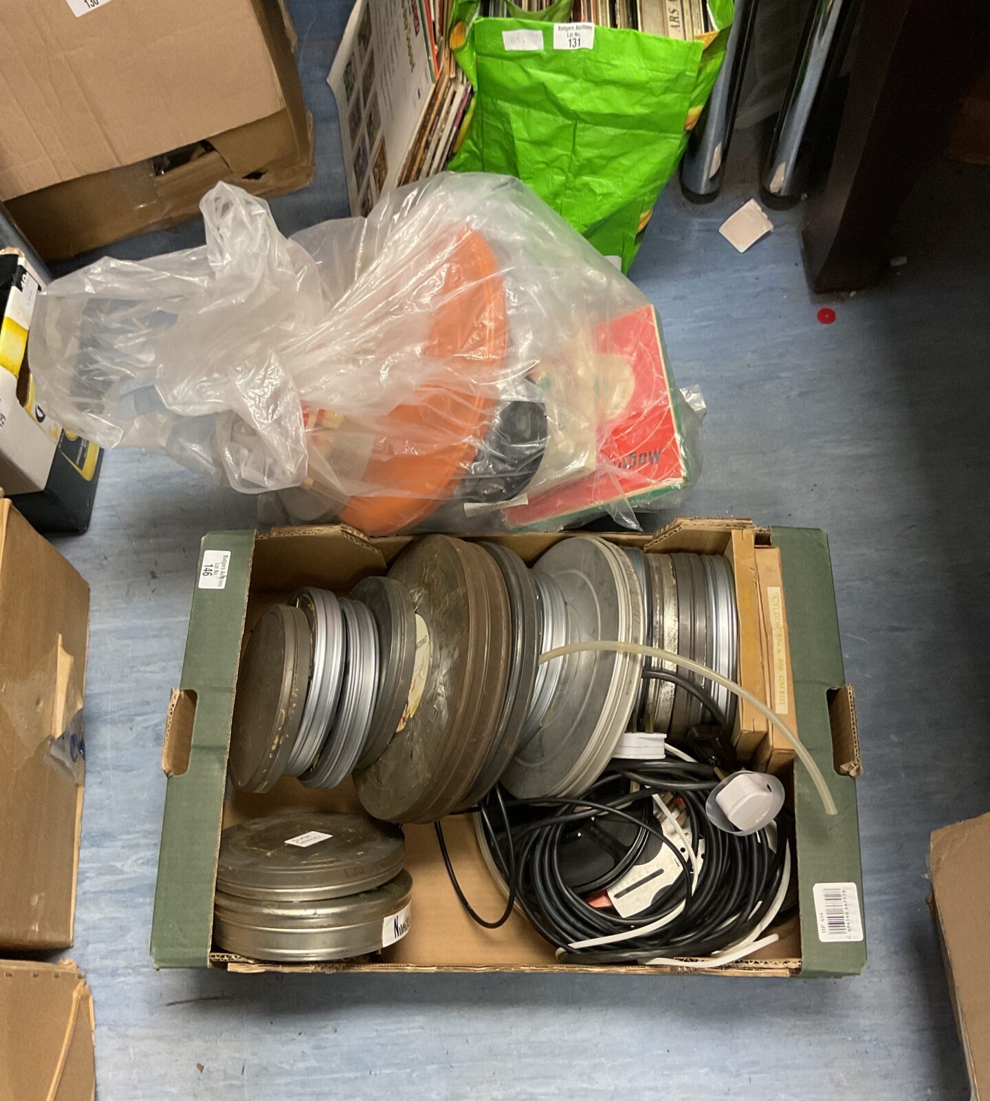 Tray & sack of projector film reels & cans