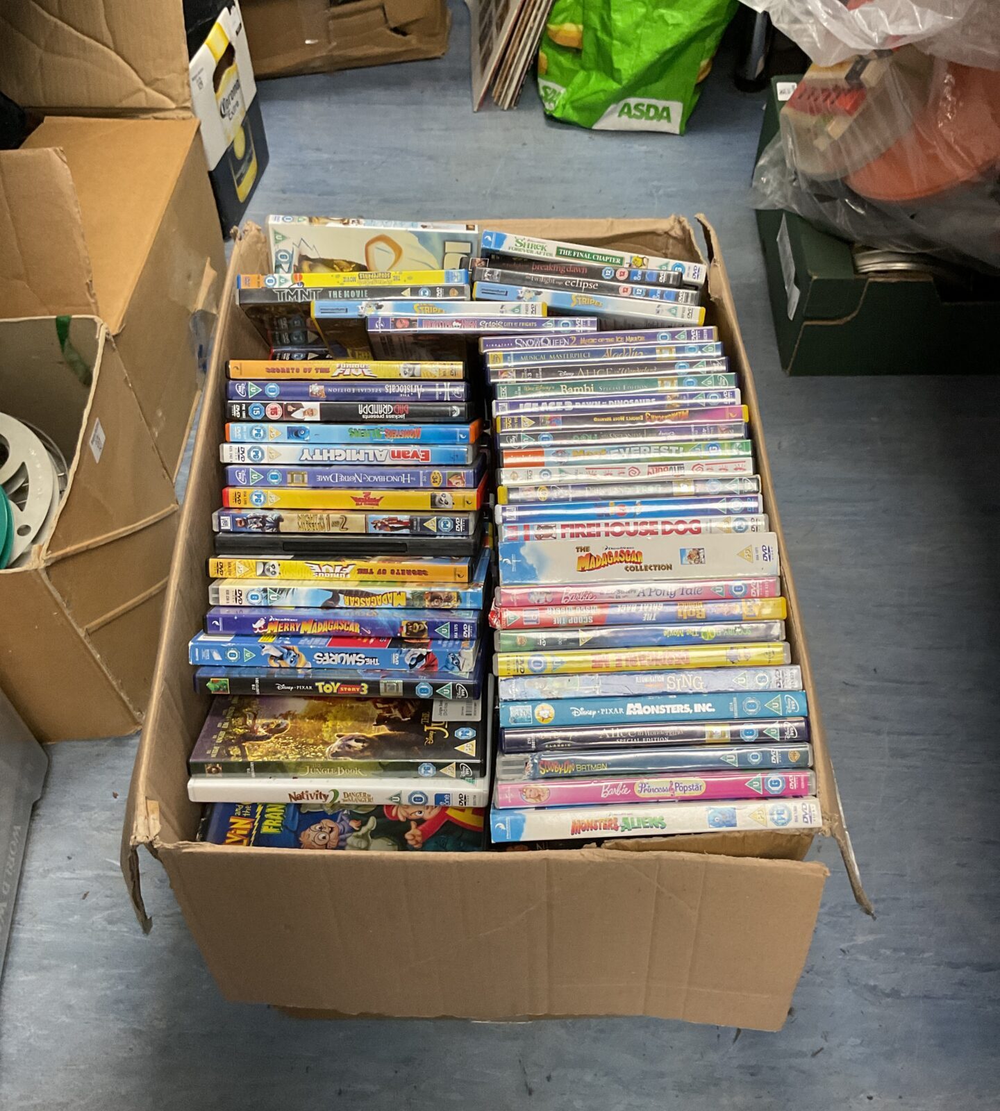 Large box of mostly childrens dvds inc disney