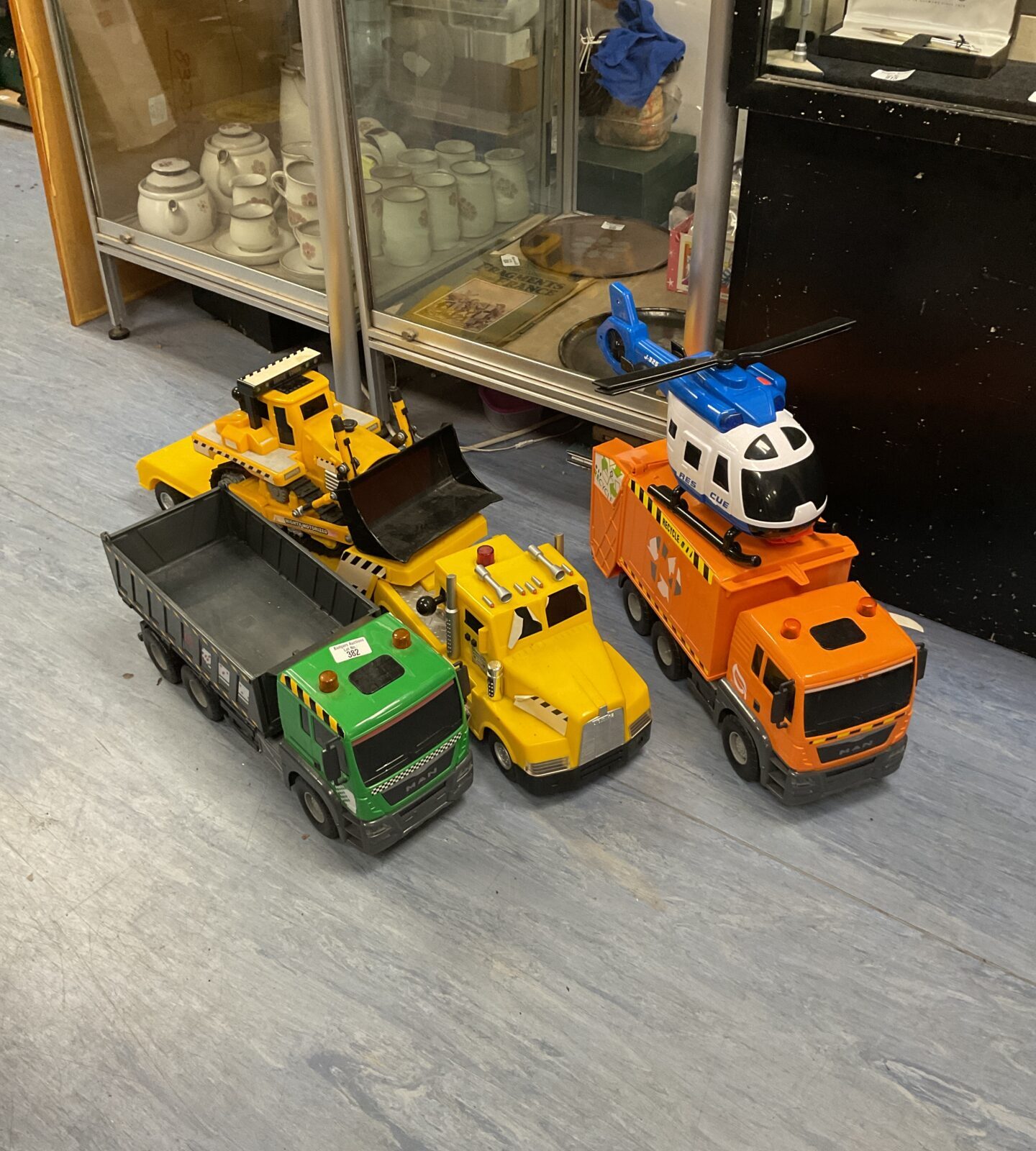 Three large Toy Lorries bulldozer and helicopter