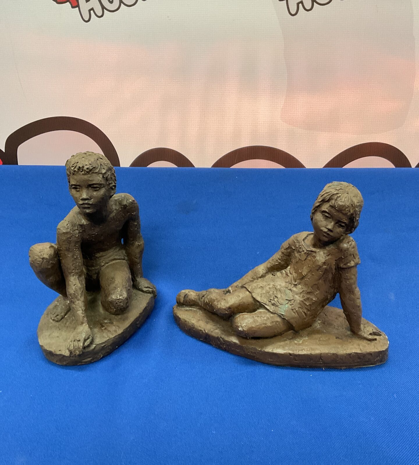 Two karin jonzen bronzed resin sculptures of children