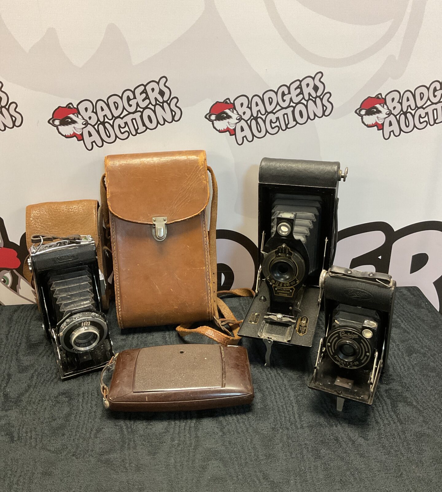 Four vintage bellows cameras including kodak brownie 3-a & ensign pocket e-20