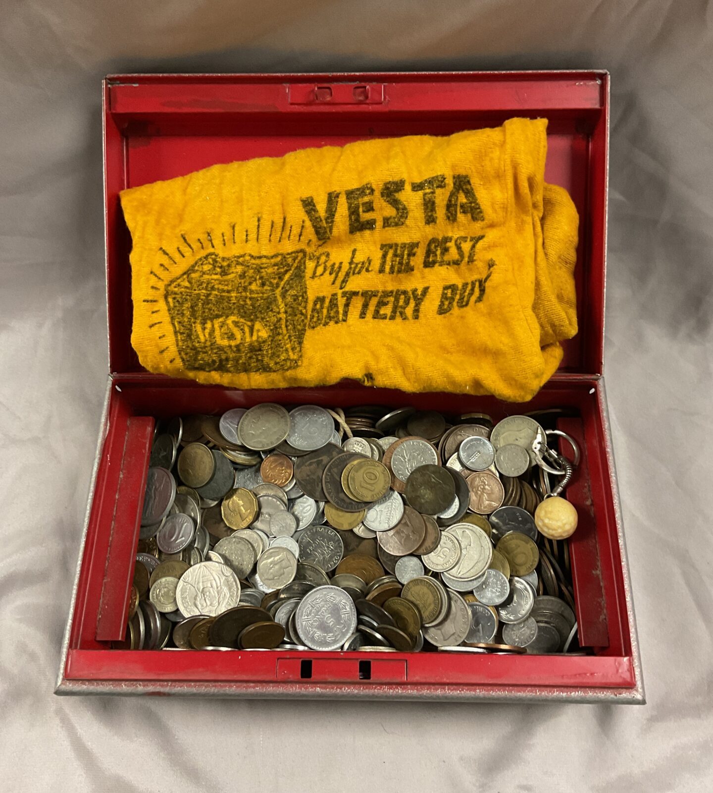 Cash tin of assorted coins