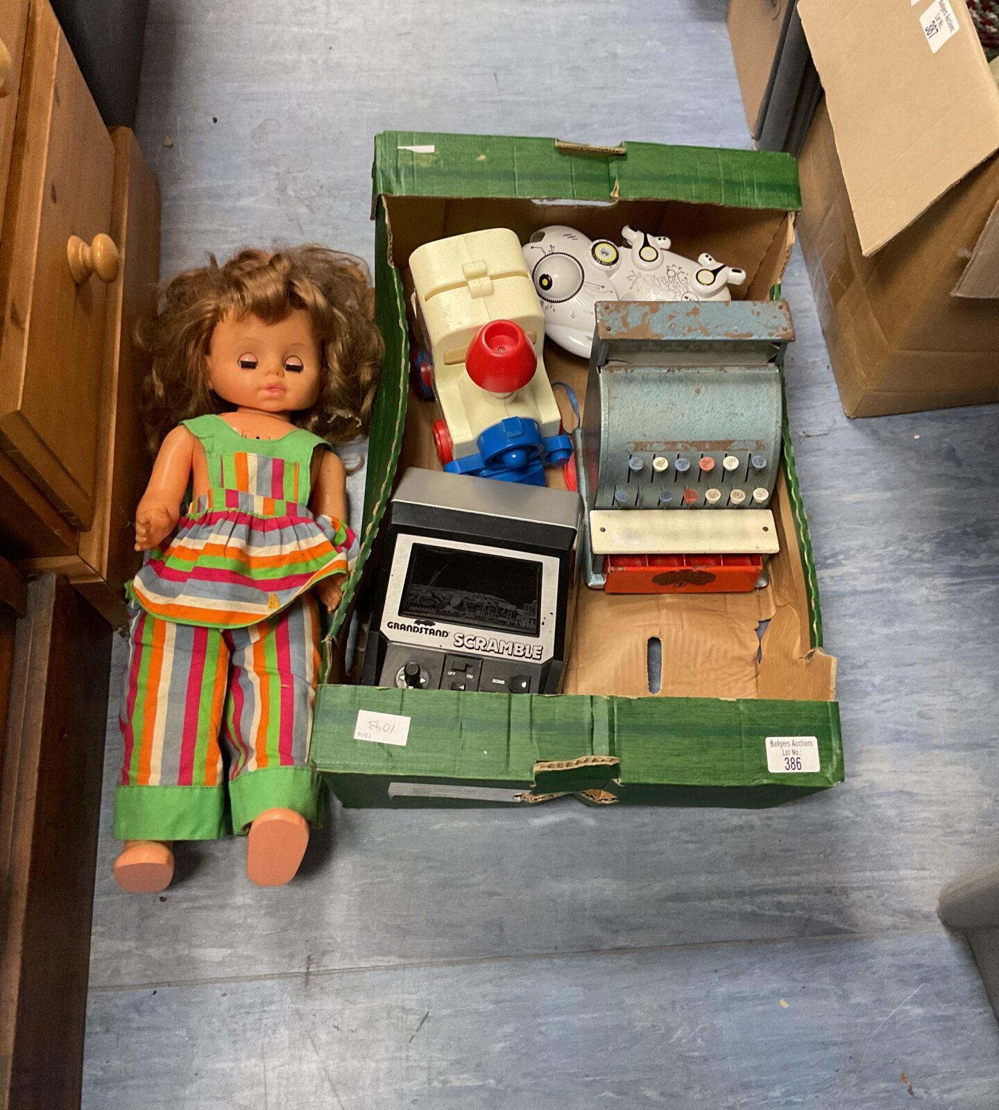 Box of mixed toys inc doll and vintage cash register