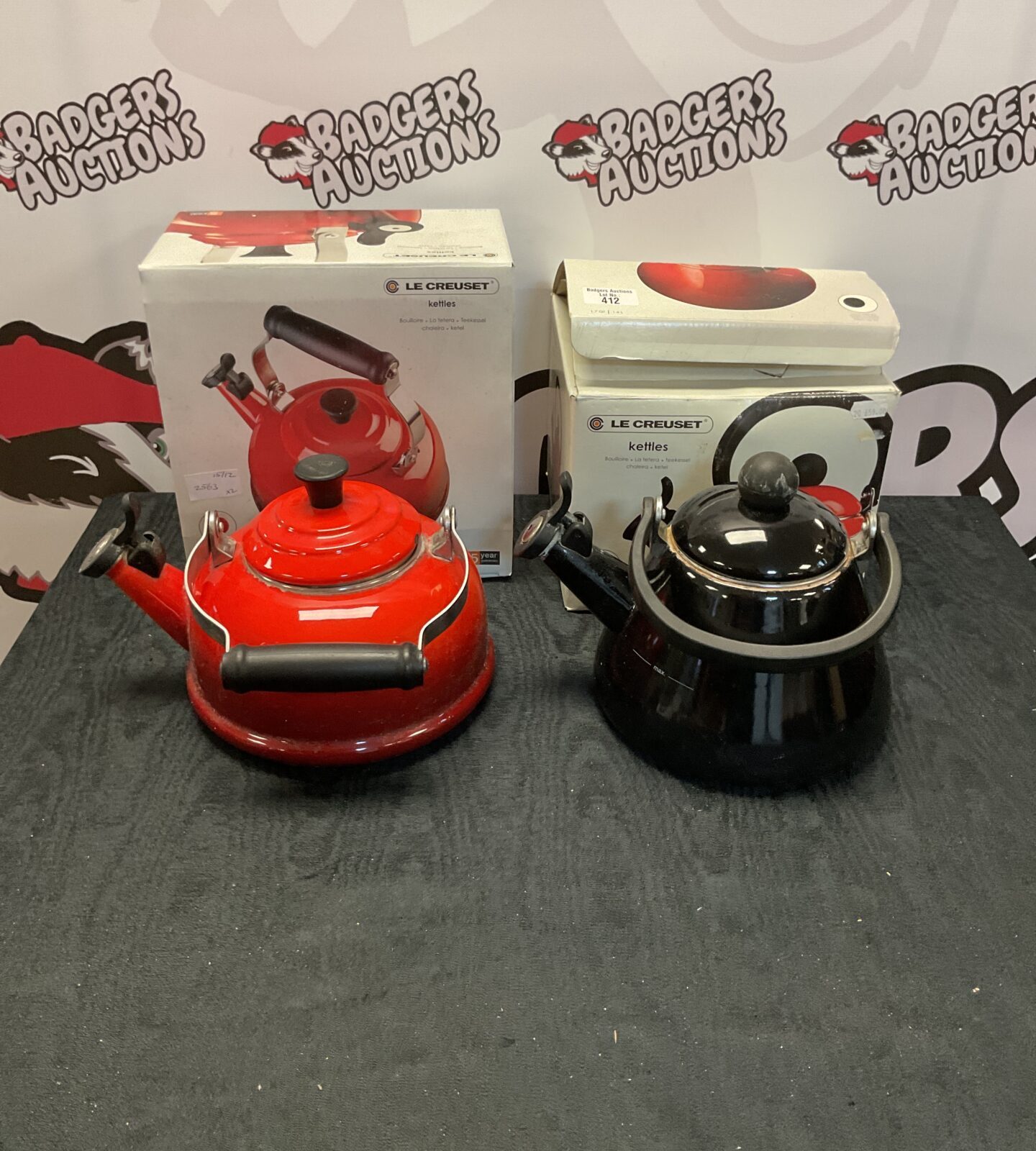 Two Le Creuset kettles one black, one red