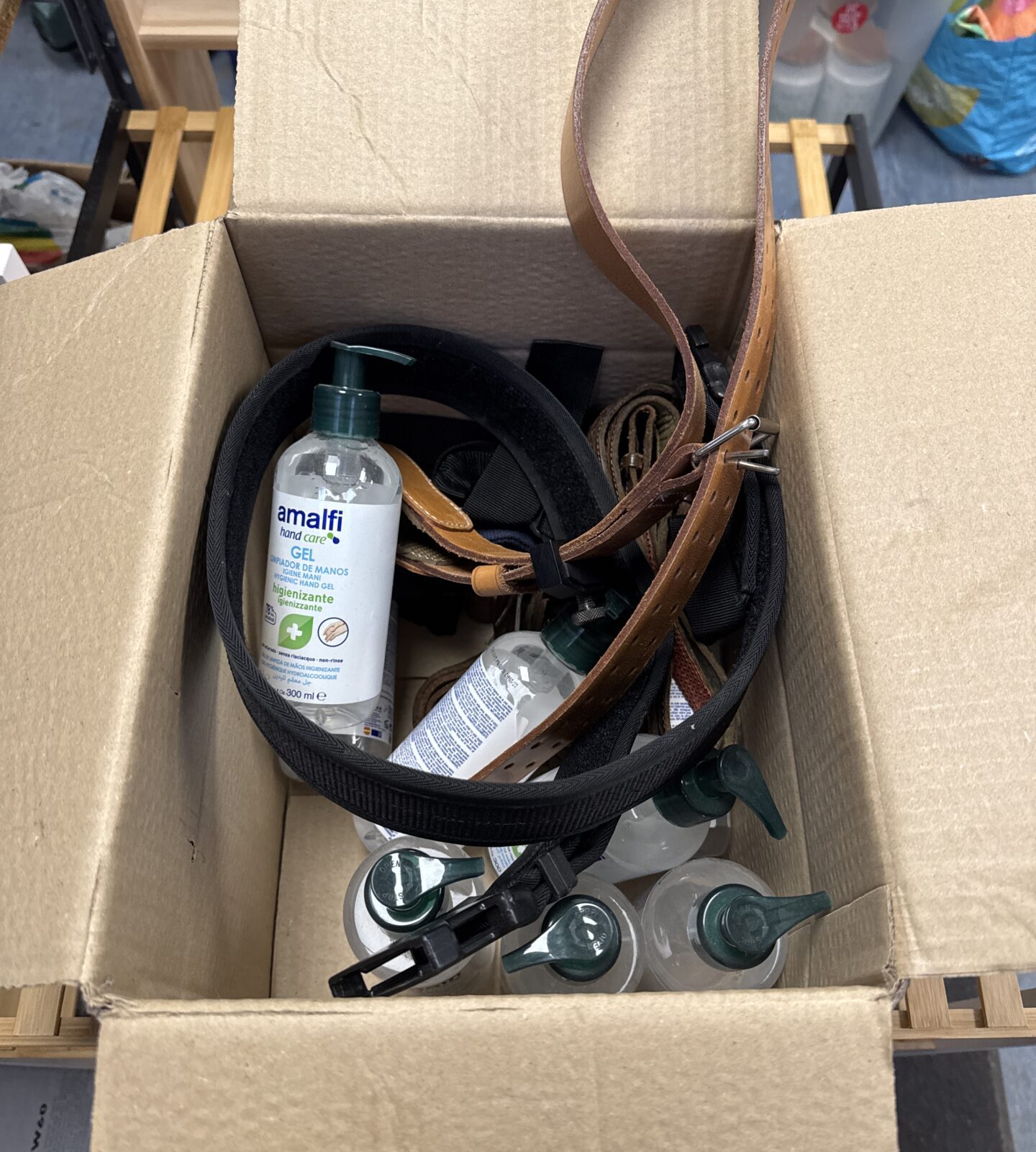 Box of hand sanitiser & assorted belts