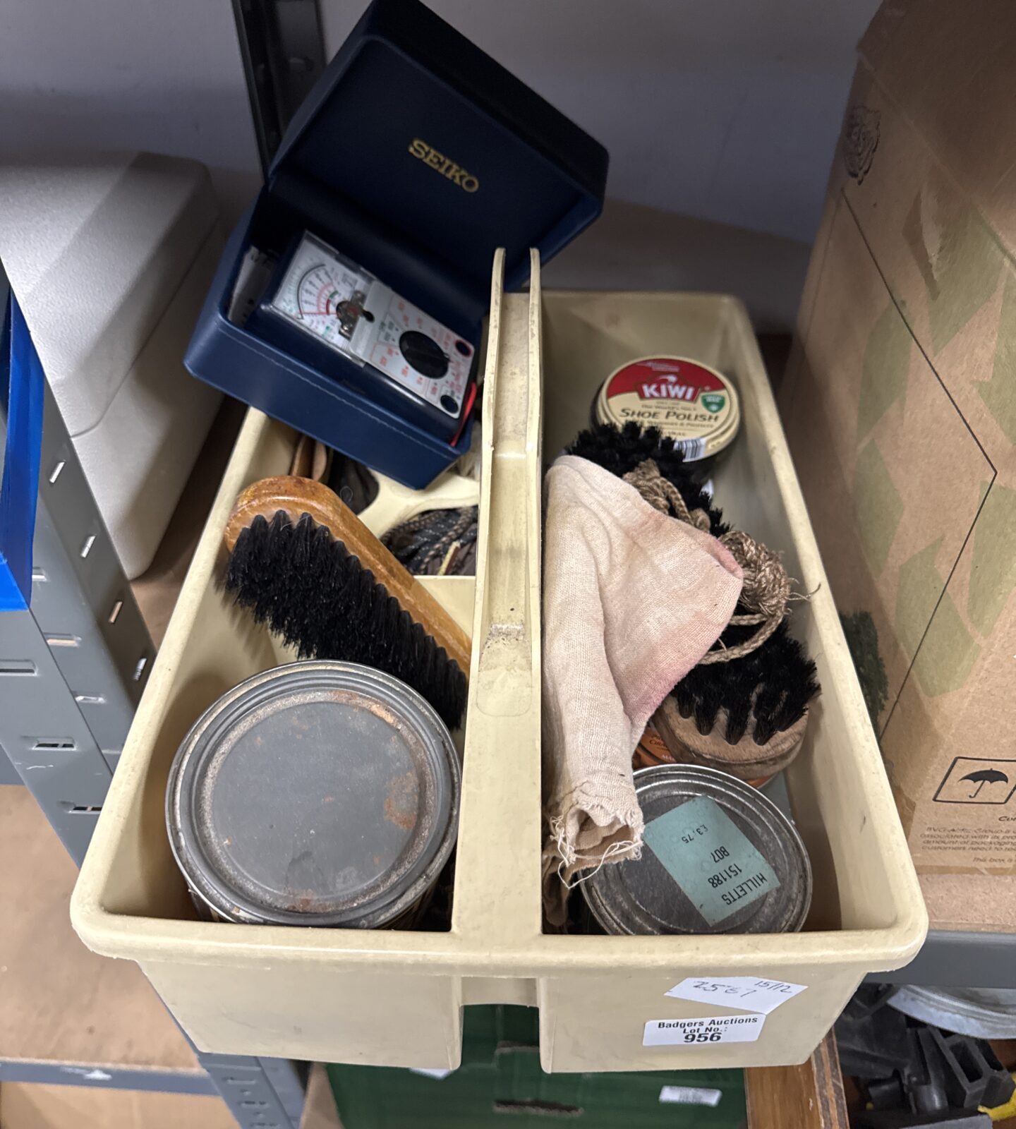 Tray of assorted shoe polish with an electrical test meter