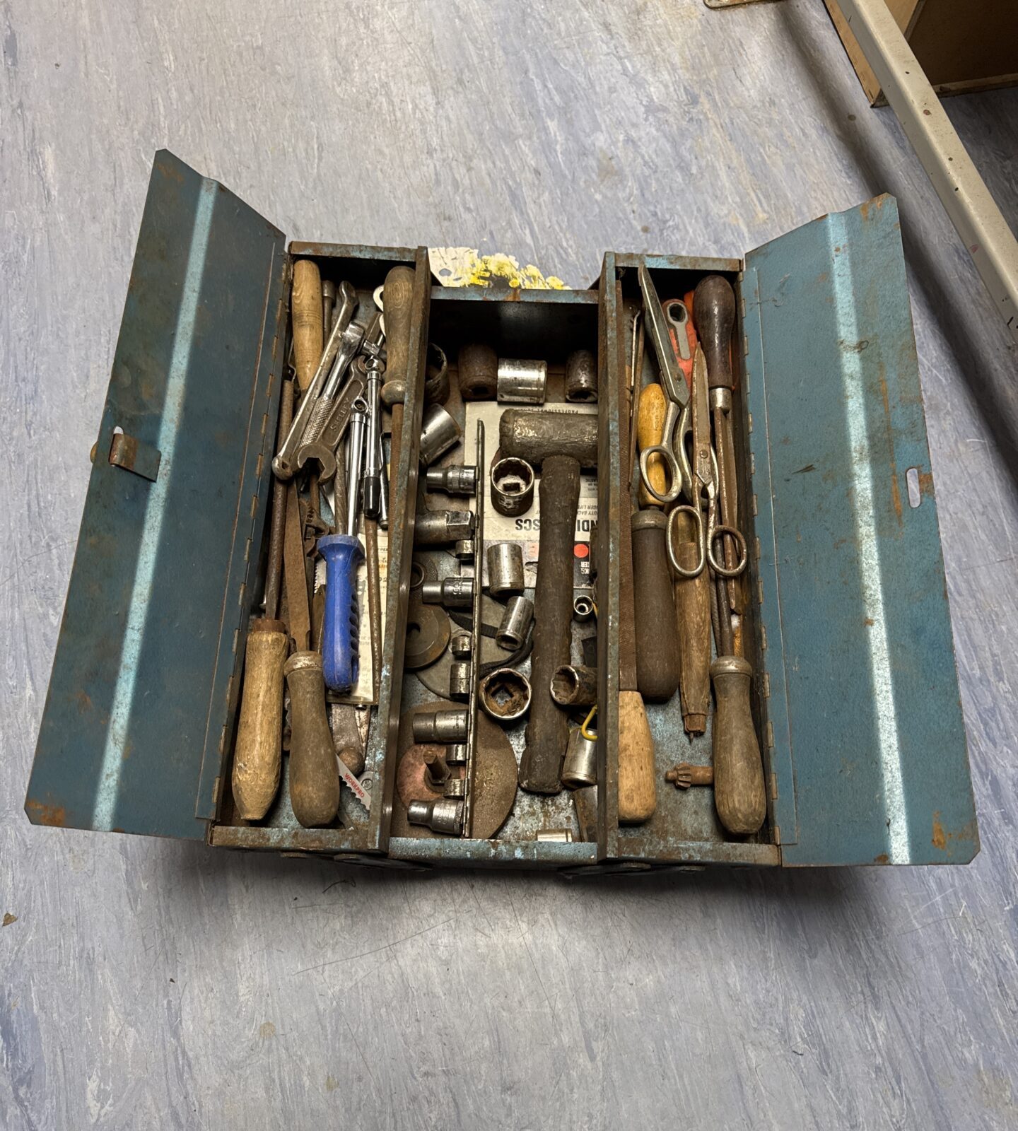 Vintage metal toolbox with contents