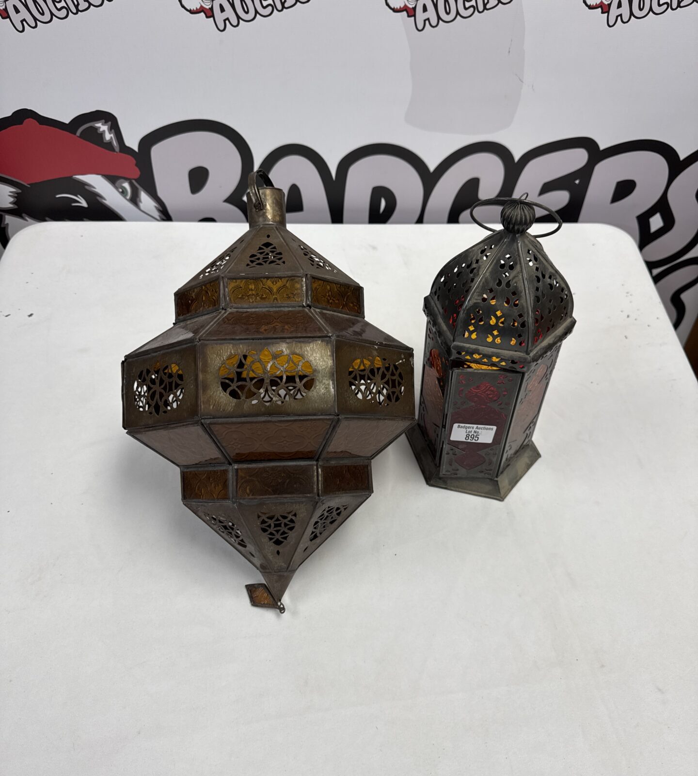 Vintage oriental style electric lantern (on left of photo) with a candle lantern