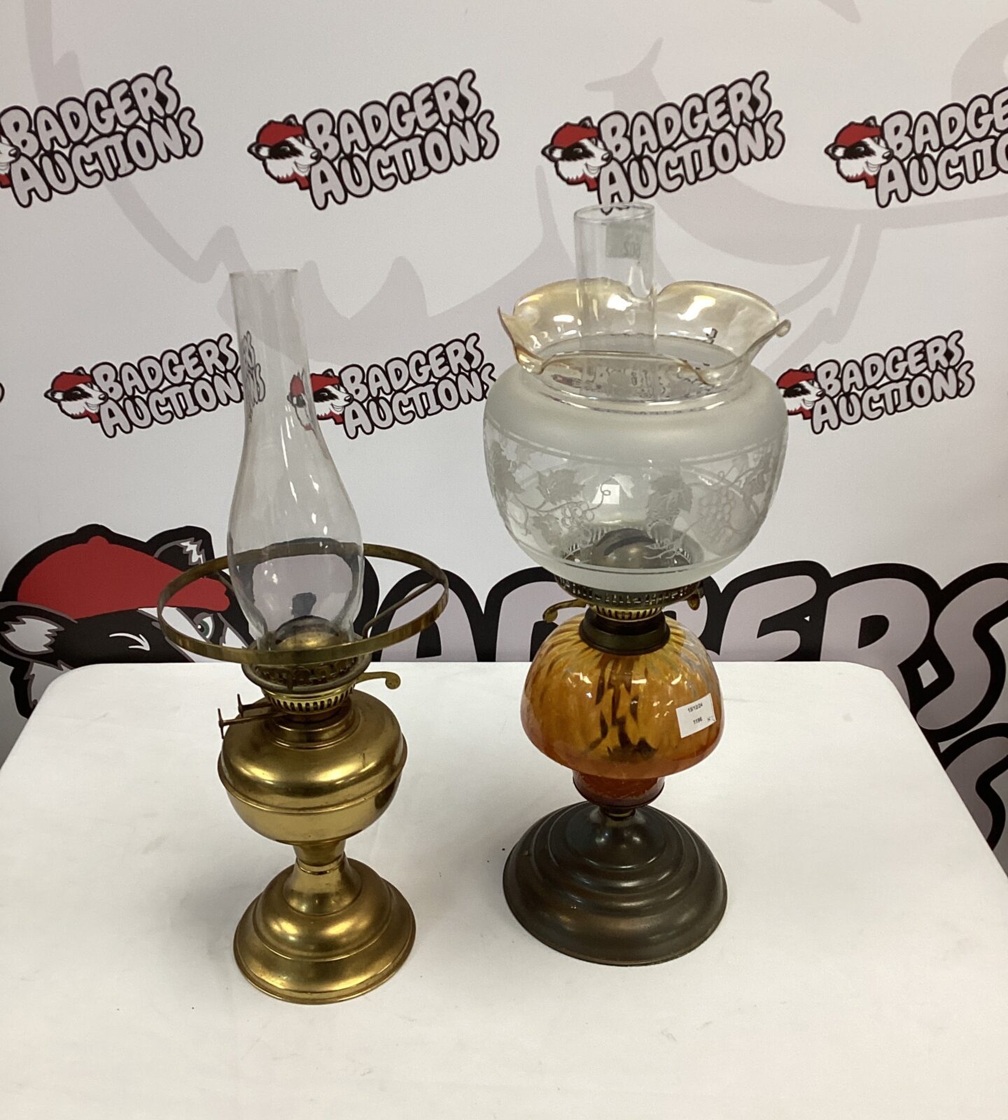 Two paraffin lamps inc brass base & glass base