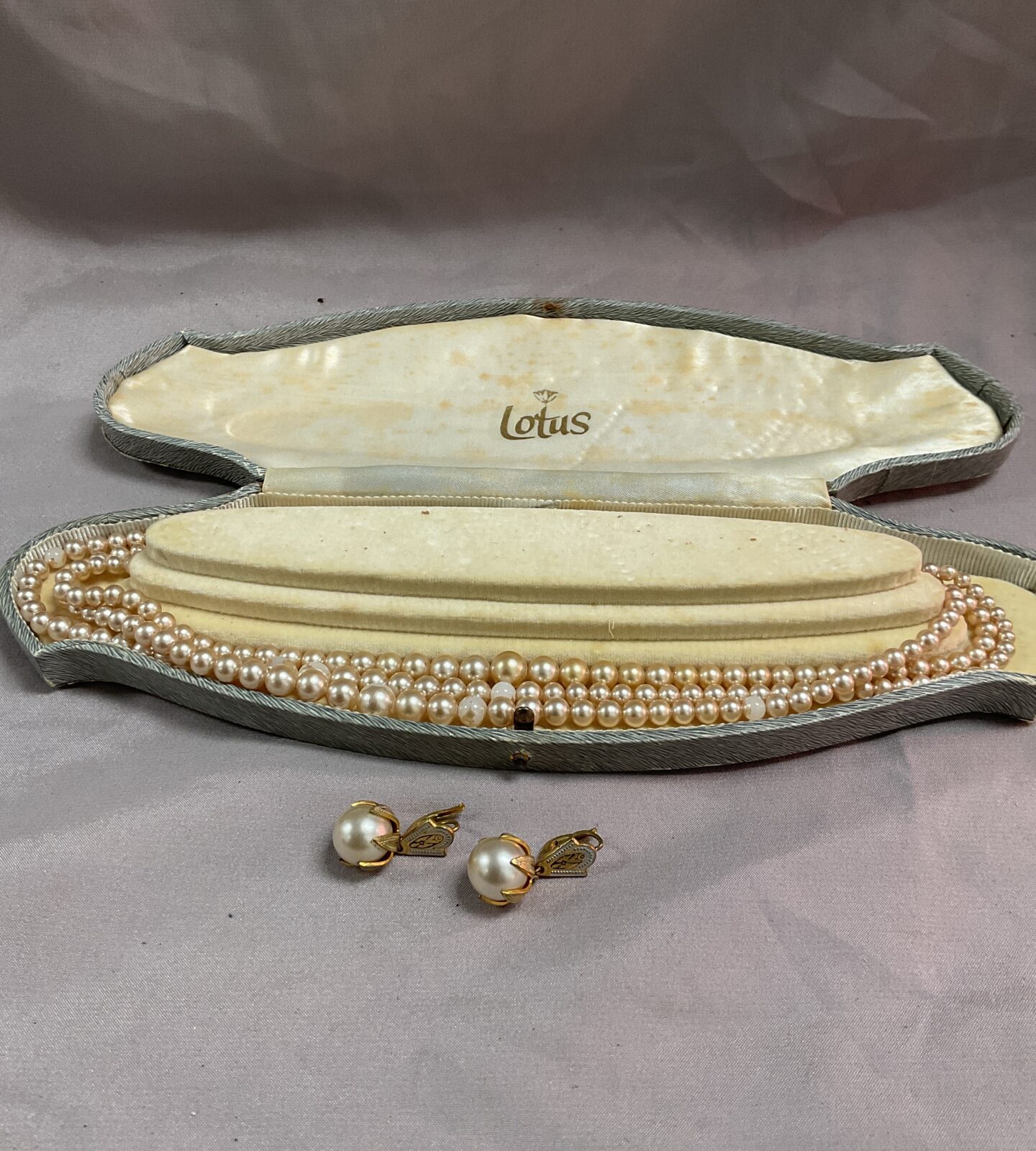 pair faux toledo clip on earrings and lotus necklace