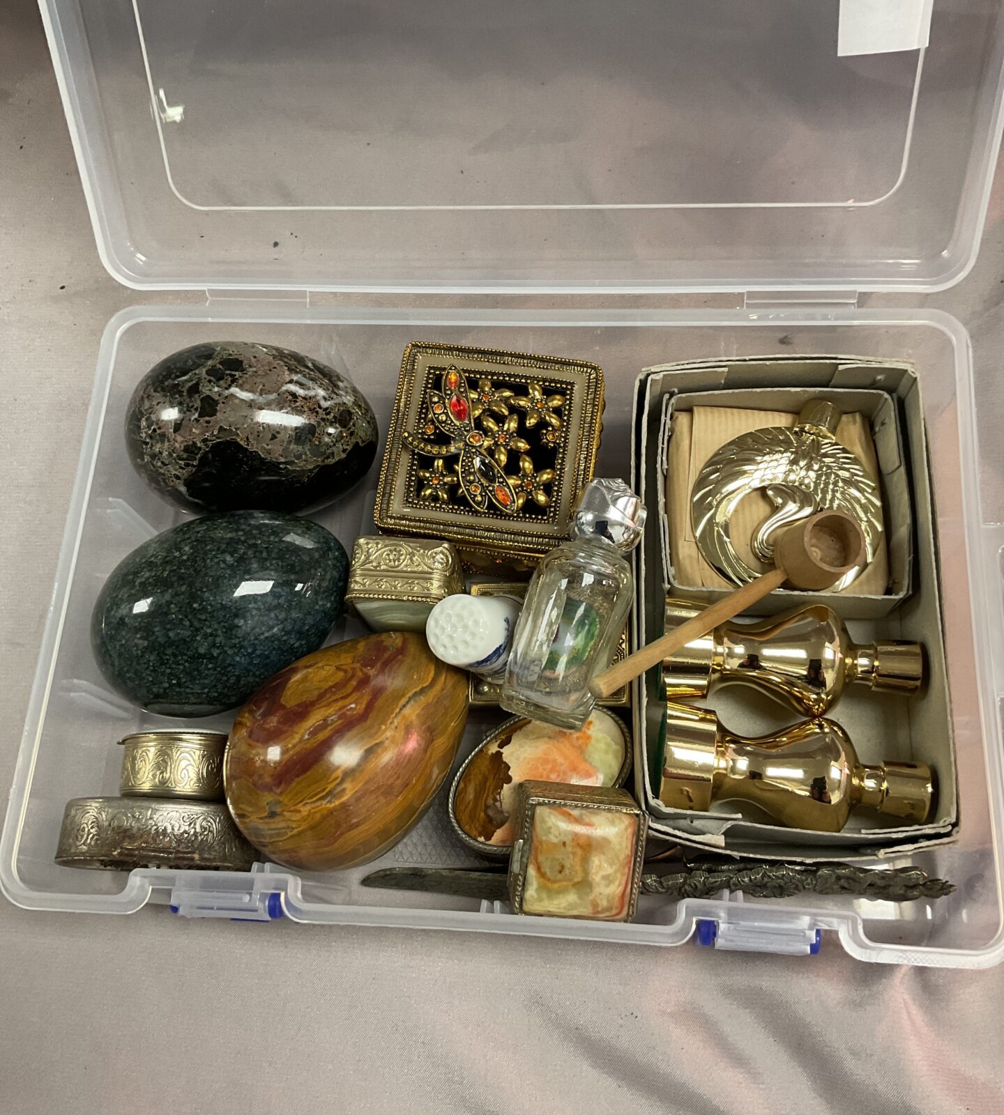 Tub of assorted pill boxes and marble eggs