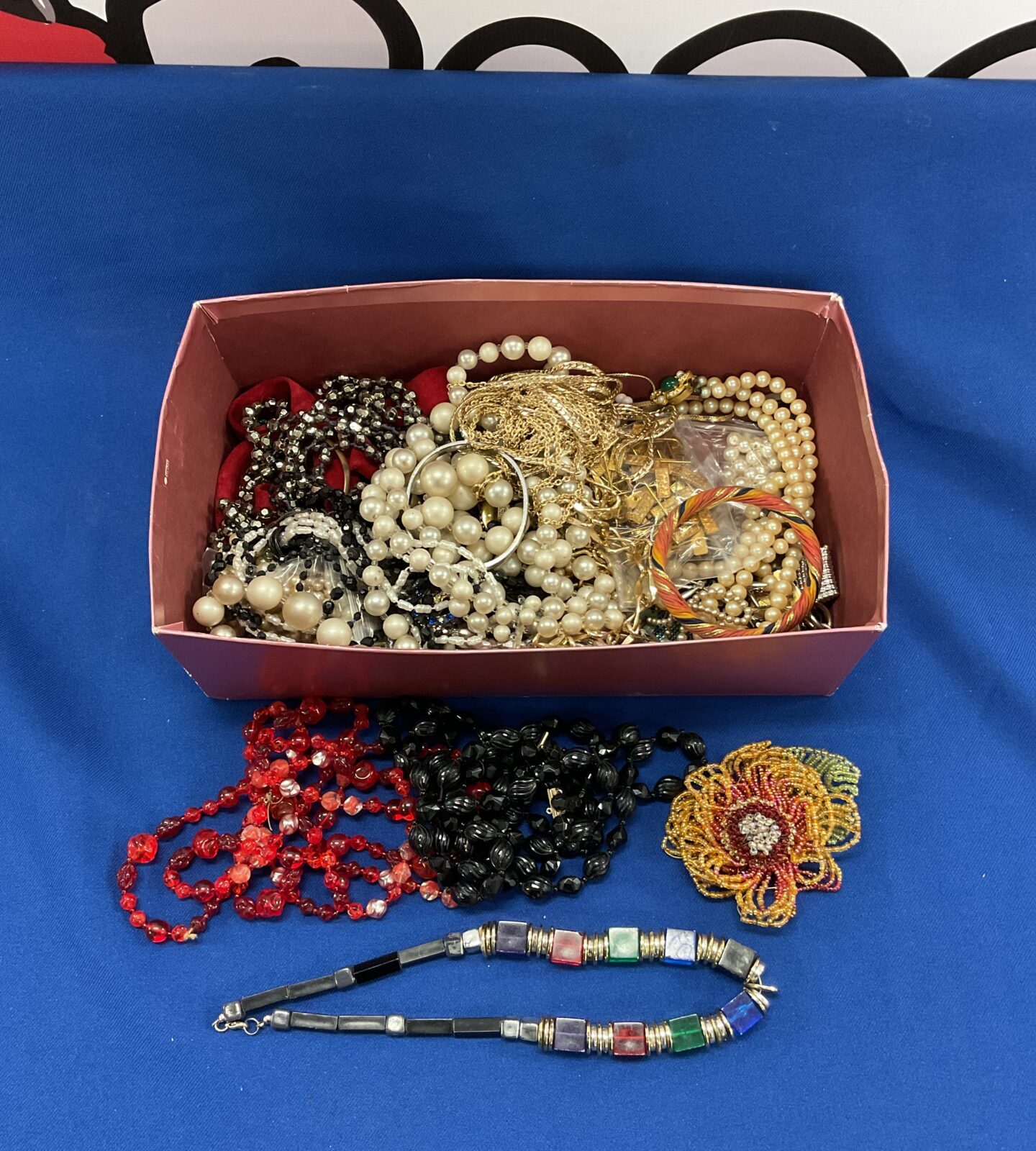 Box of costume jewellery including red glass bead necklace