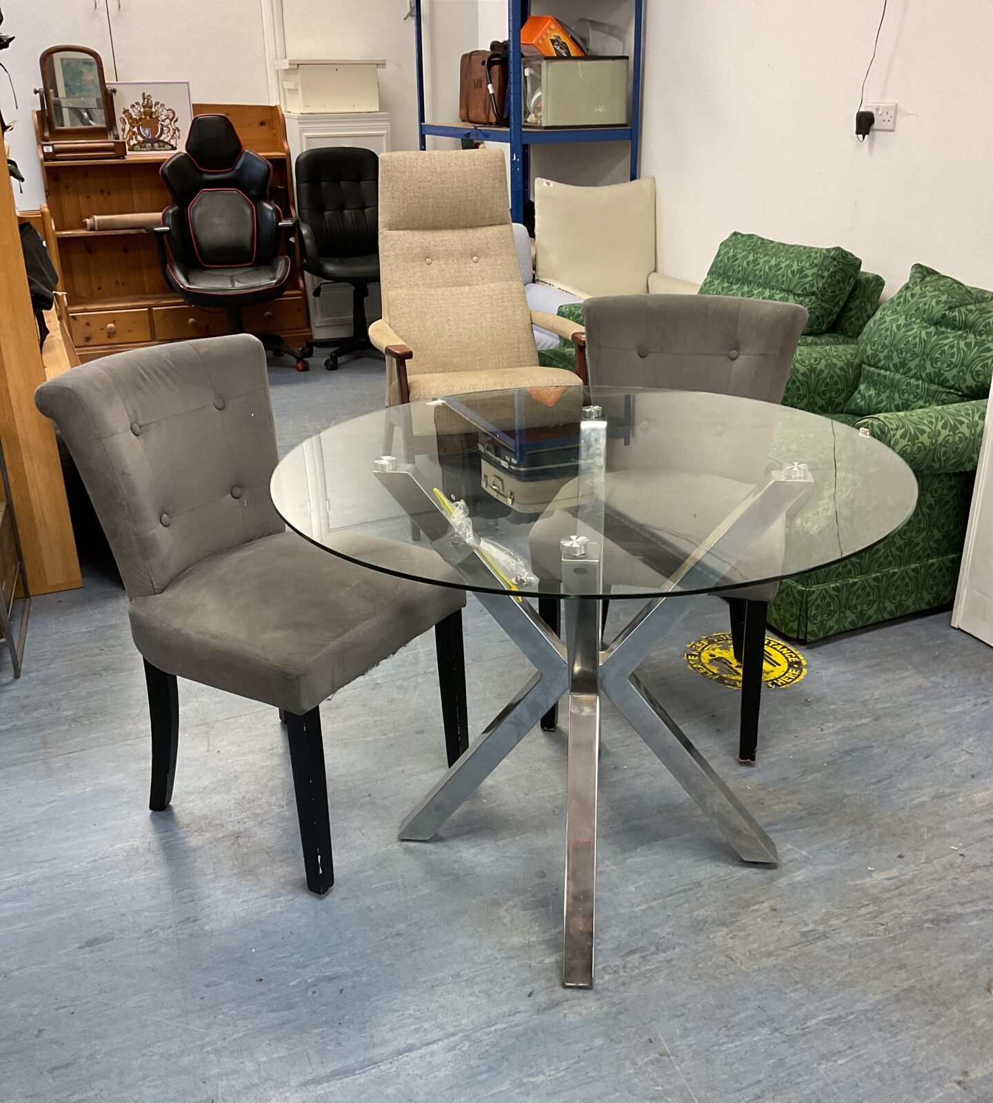 Round glass topped dining table with 2 chairs