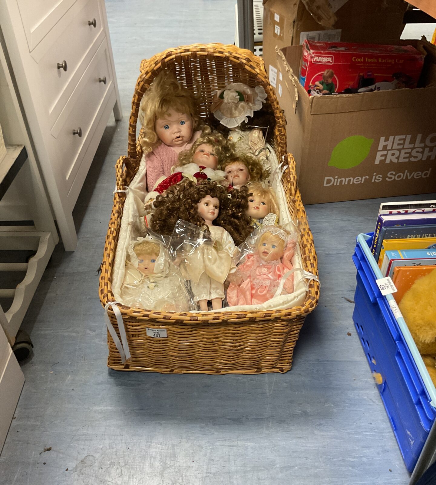 Selection of mixed dolls with wicker moses basket