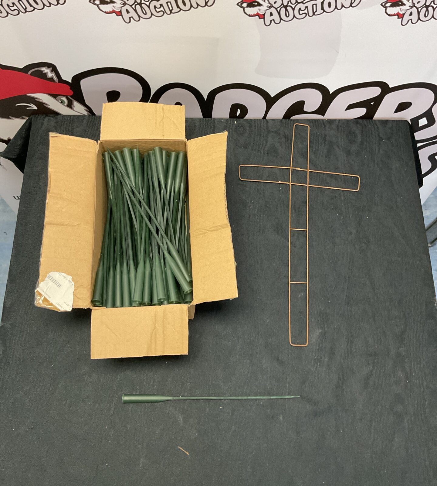 Box of orchid tubes and a metal wire cross