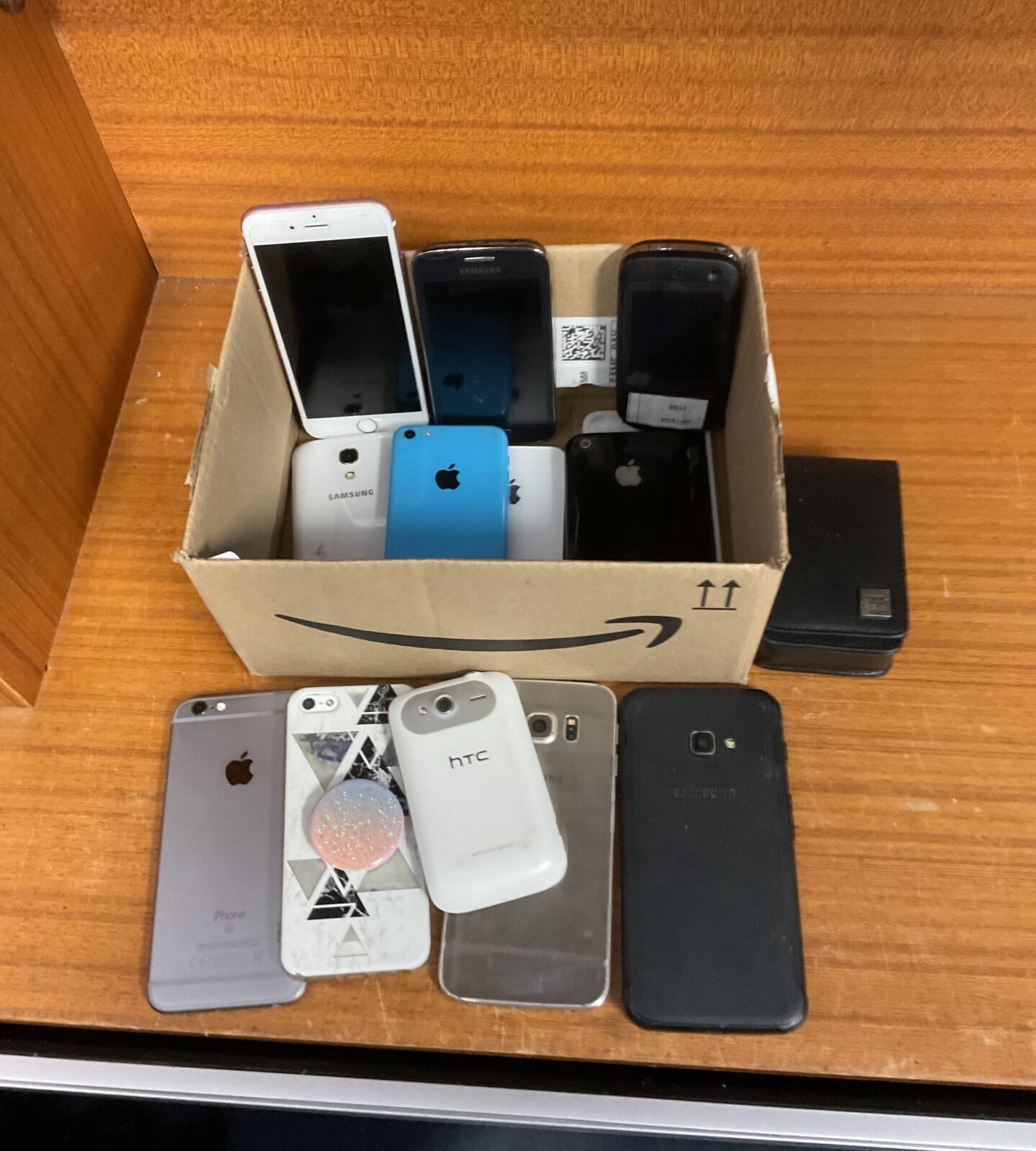 Box of mobile phones including apple & samsung