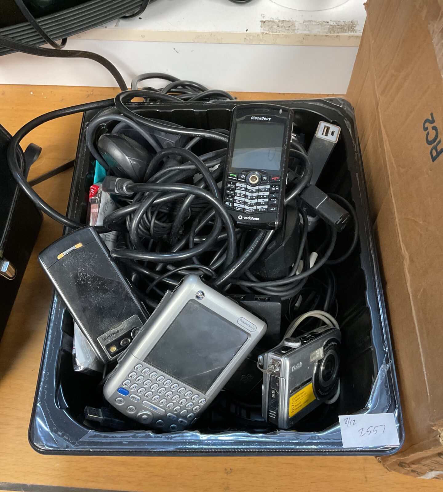 Tray of cameras, cables & mobile phones