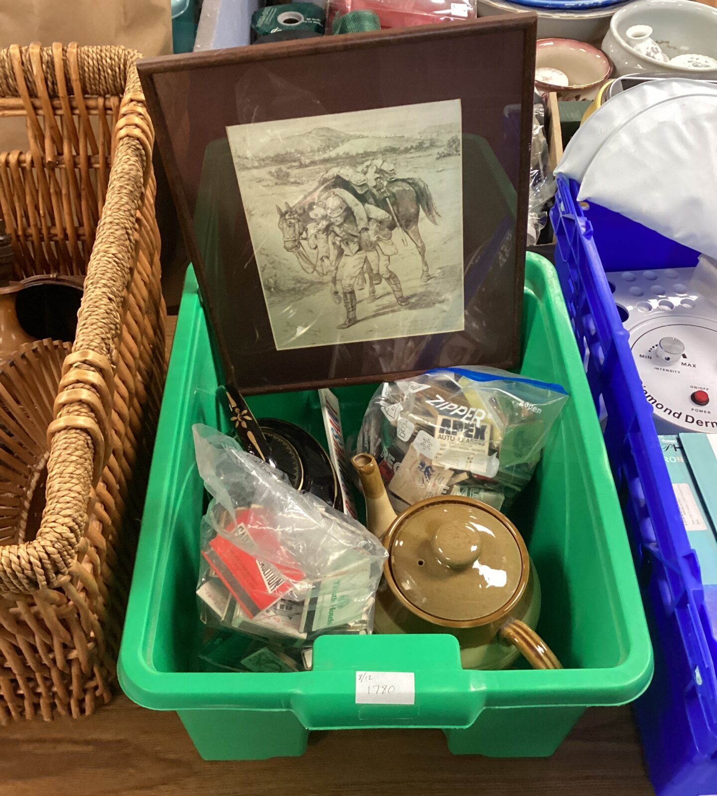 box of mixed teapots and matches and framed military rescue print