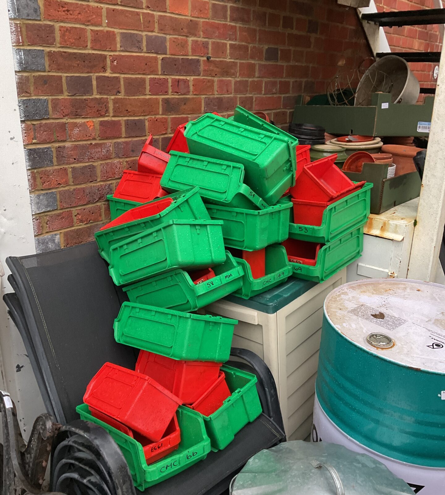 Large lot of wall racking with plastic storage tubs