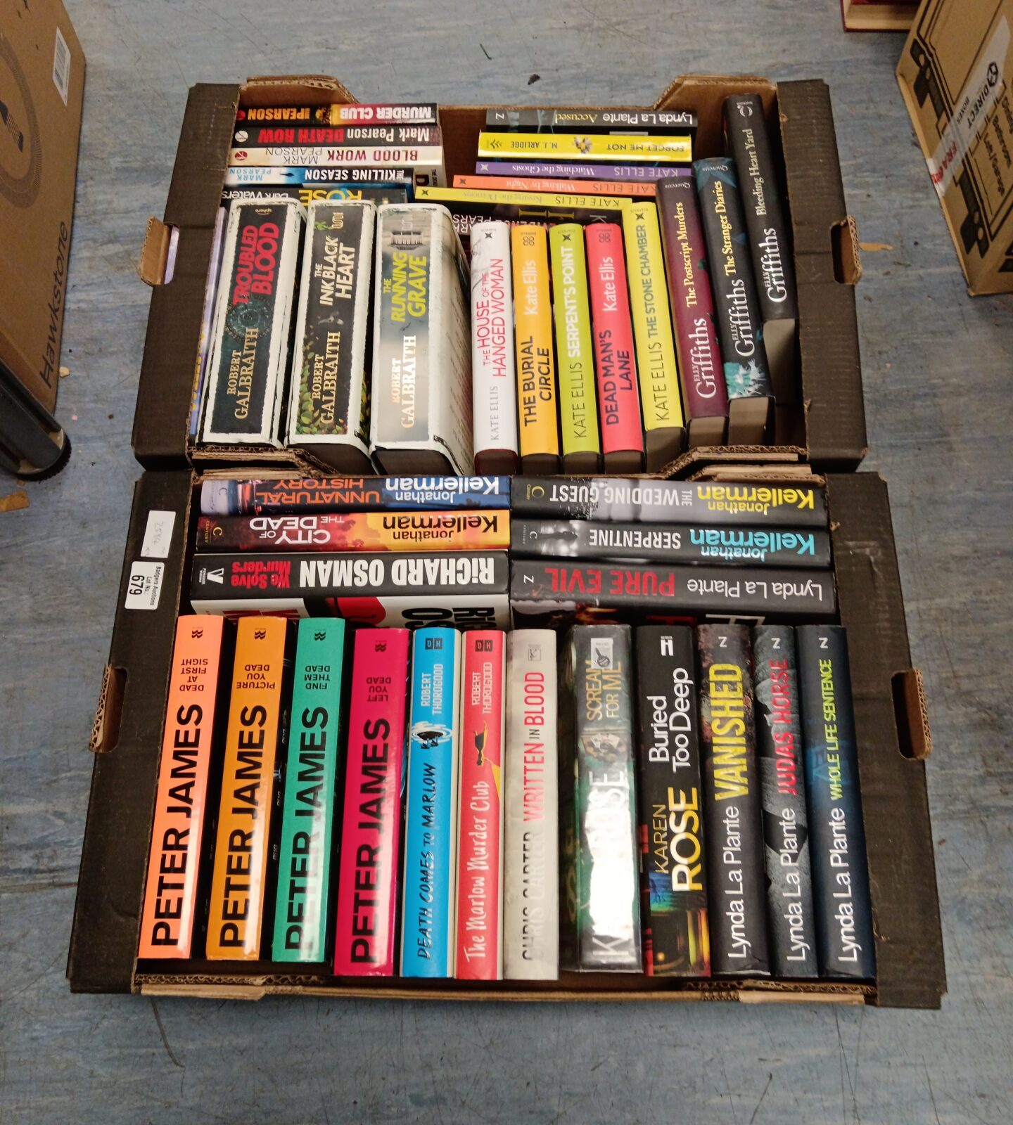 Two trays of books including Peter James & Richard osman