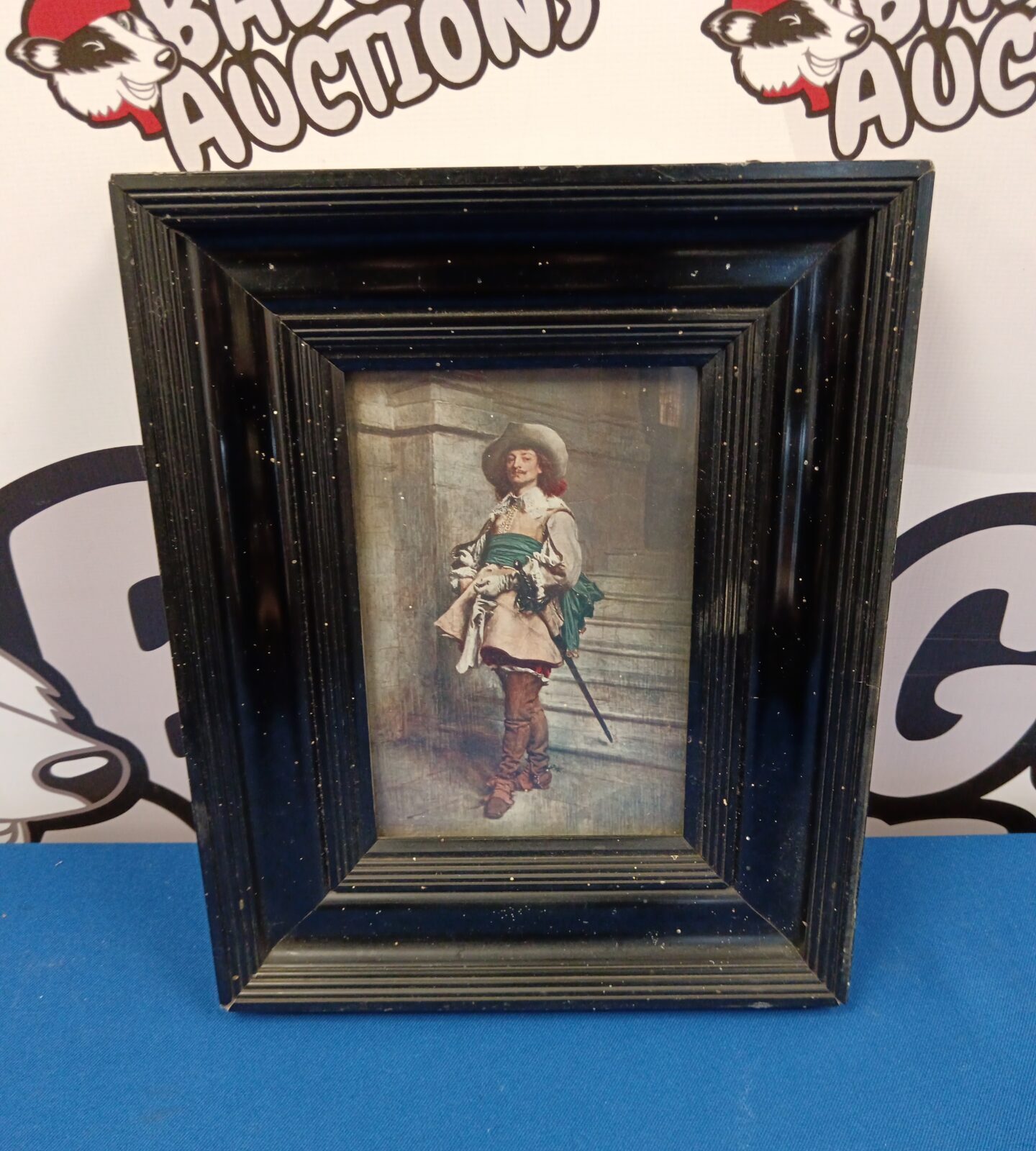 Vintage print of musketeer in black lacquered frame