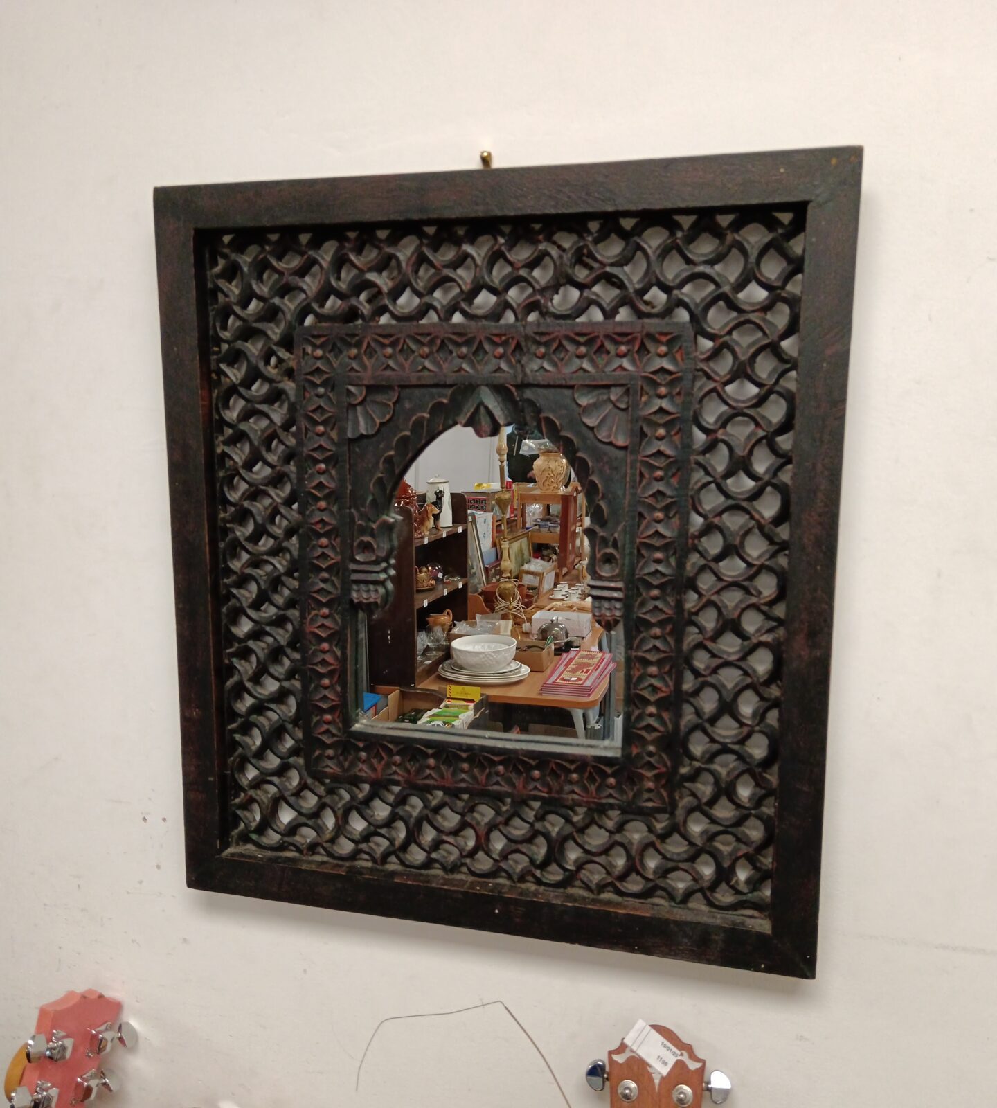 Ornate wooden framed Indian mirror