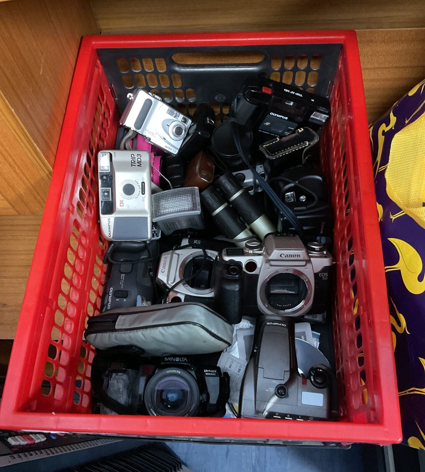 Box full of cameras including canon & olympus