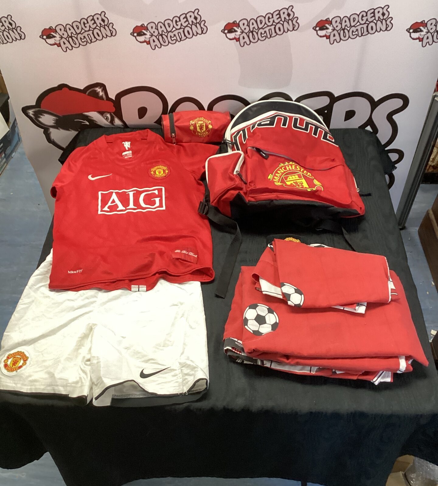 box of manchester united kit, rucksack, pencil case and duve set