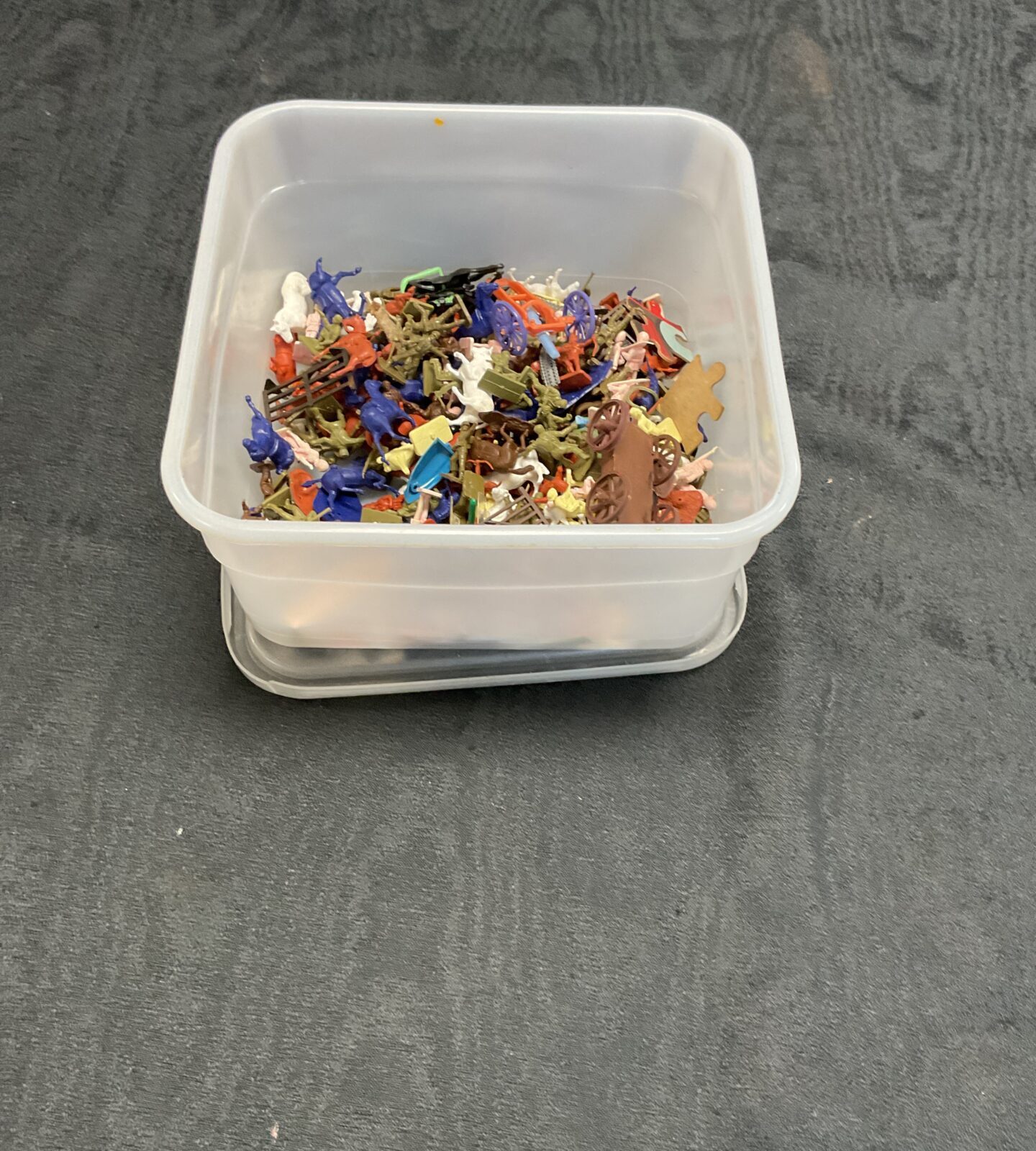 Box of miniature farm animals and army soldiers