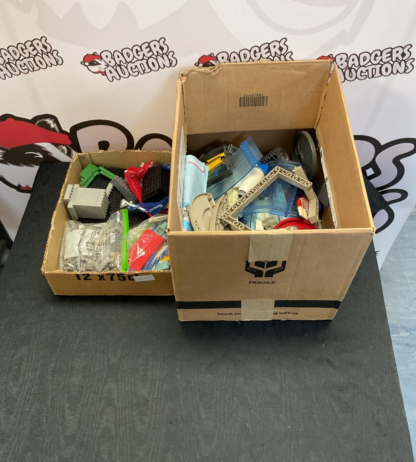 Box of playmobile and box of lego compatible bricks