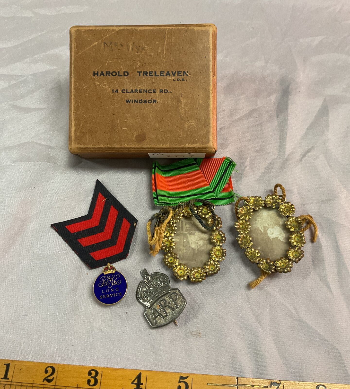 Box with twominiature picture frames A R P Badge and Long service badge