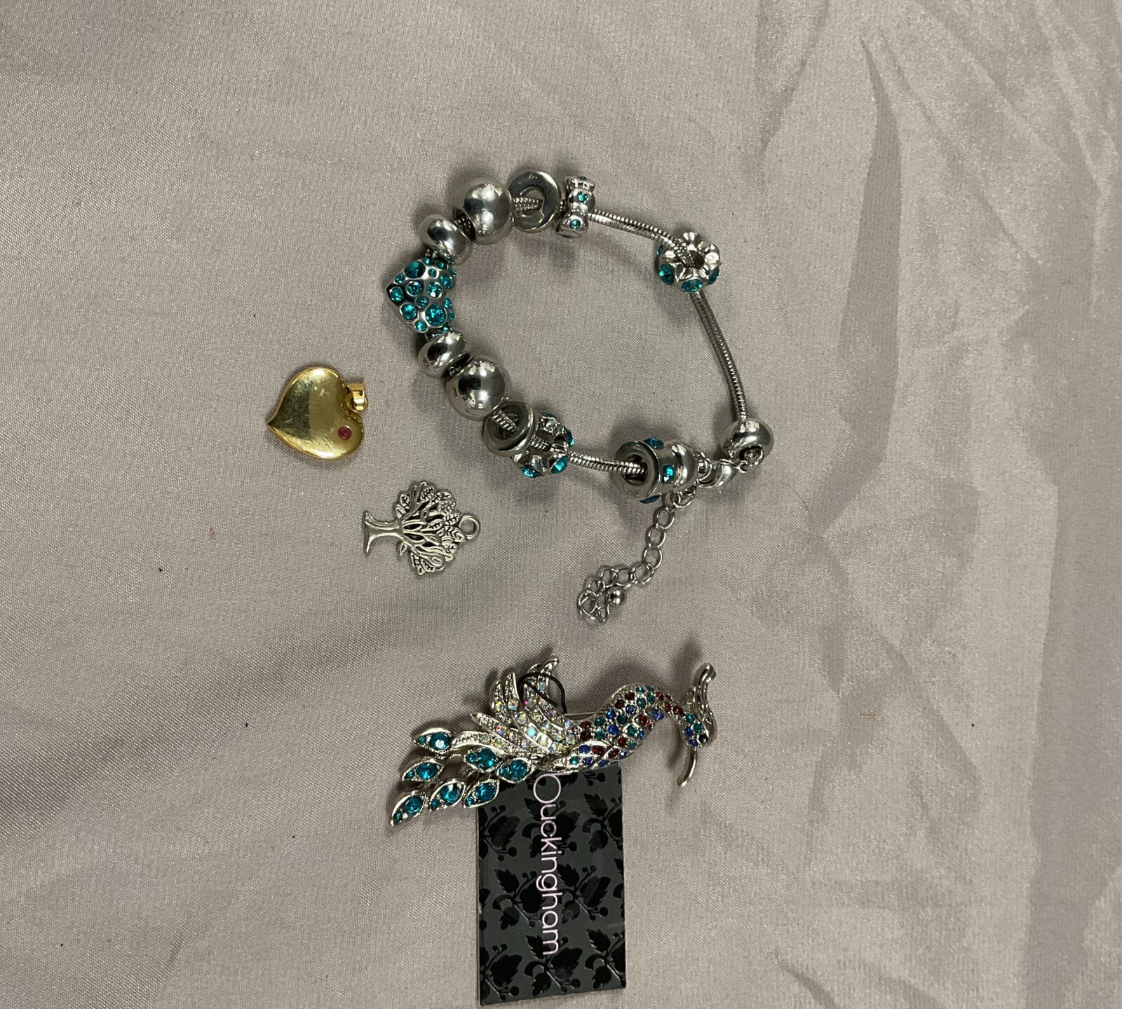 charm bracelet, brooch & two pendants