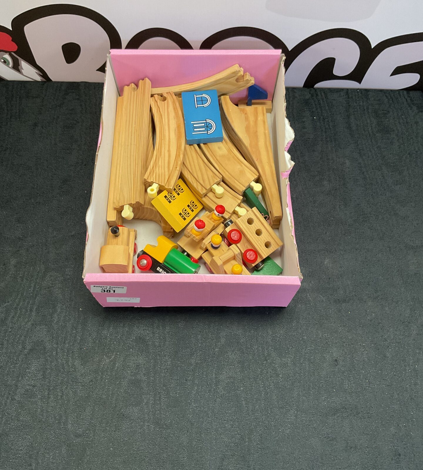 Box of wooden brio train tracks with trains